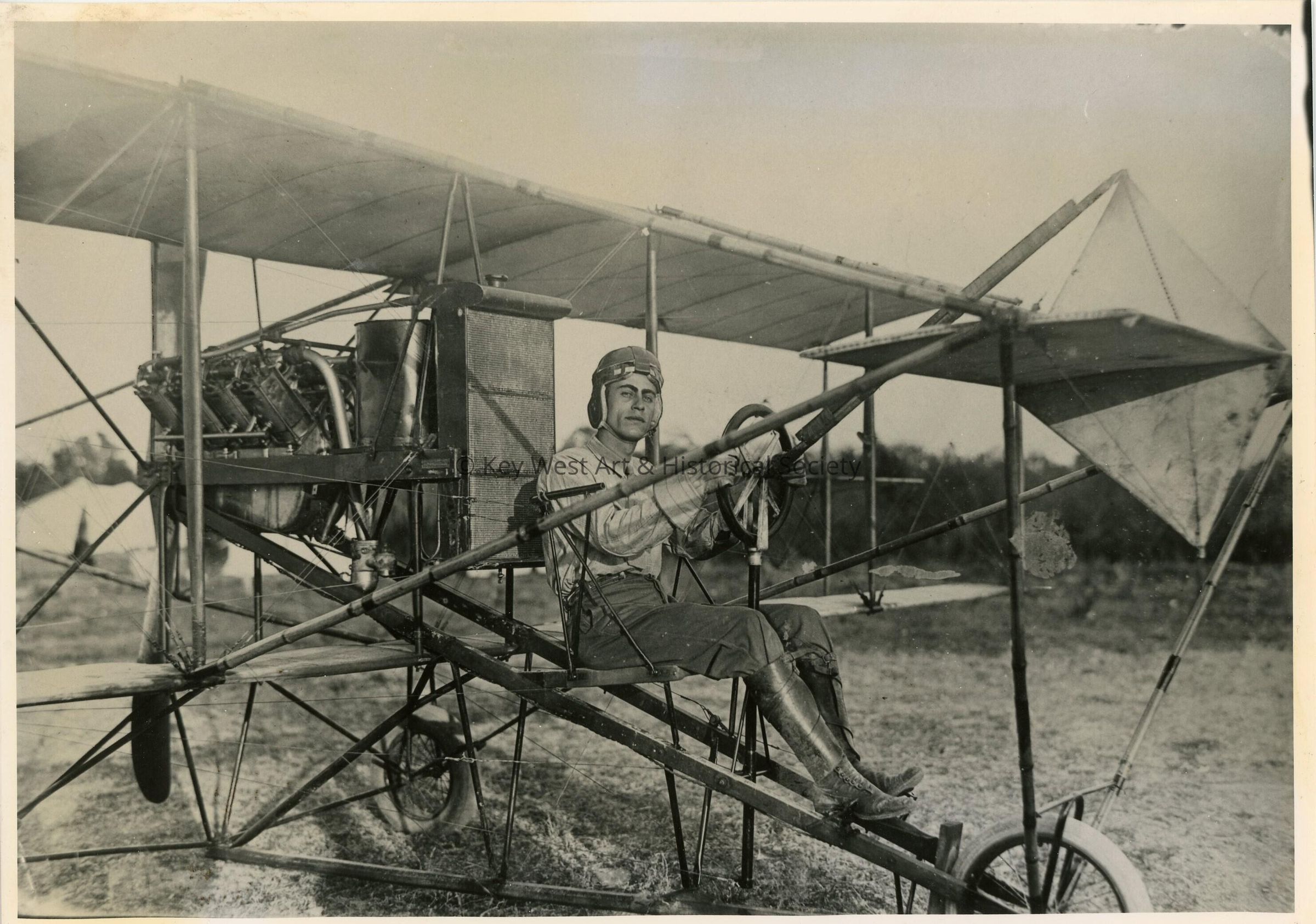 An unknown man sitting in some sort of plane