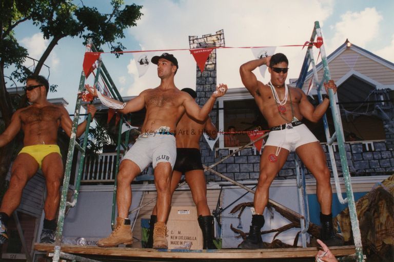 4 unknown men dancing on a stage.