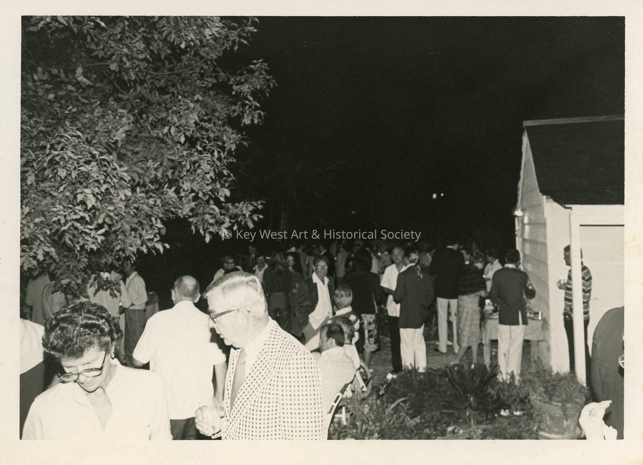 A group of people standing around outside