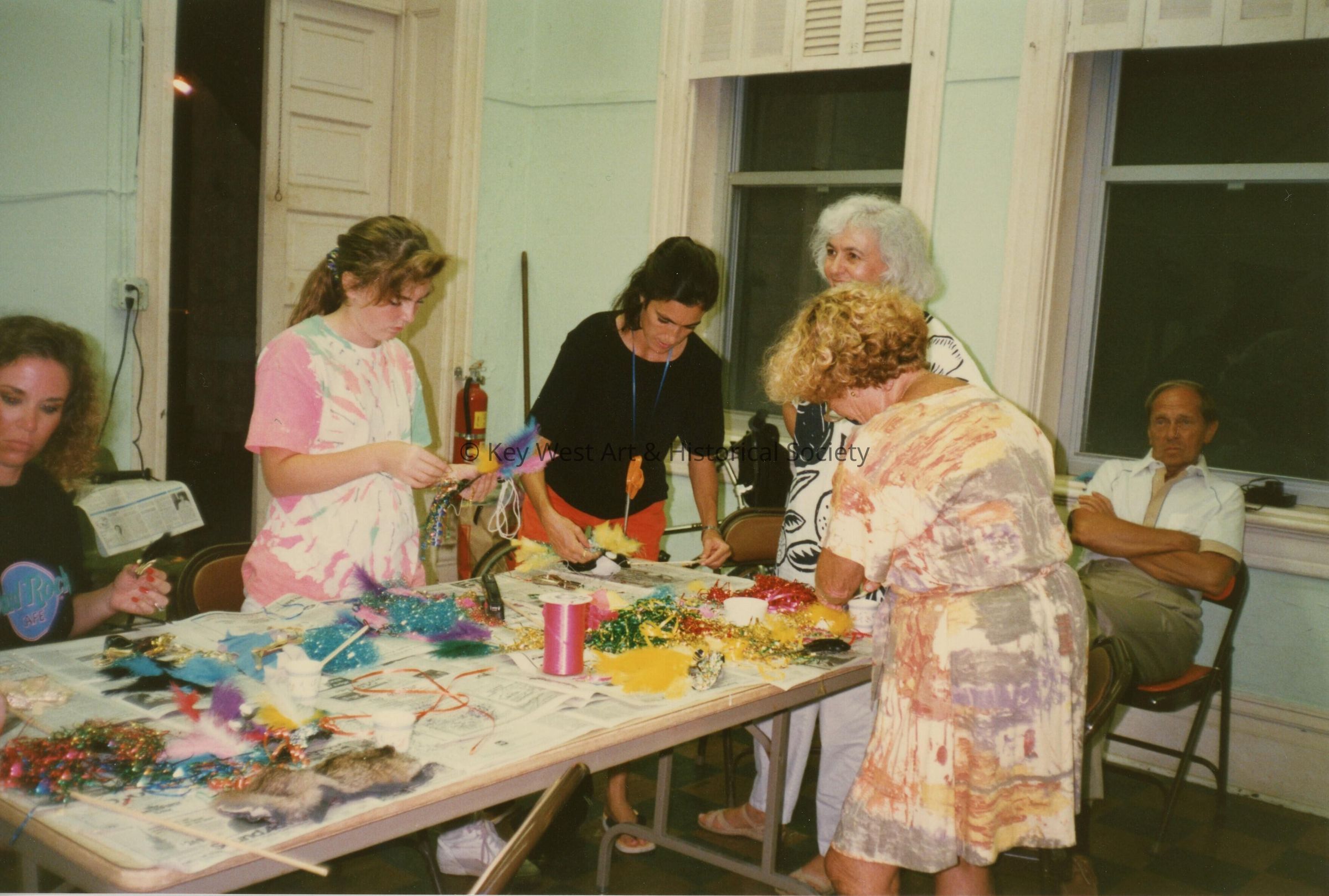 A group of unknown people making face masks.
