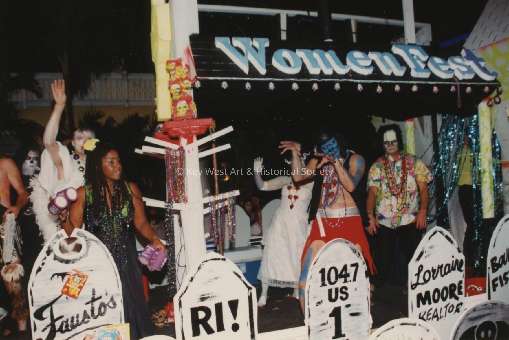 A float in the parade that reads Woman Fest.