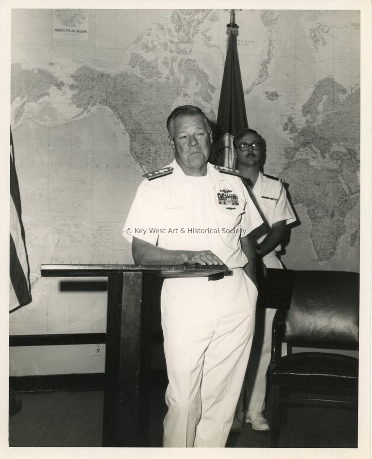 2 Men in uniform standing in a room