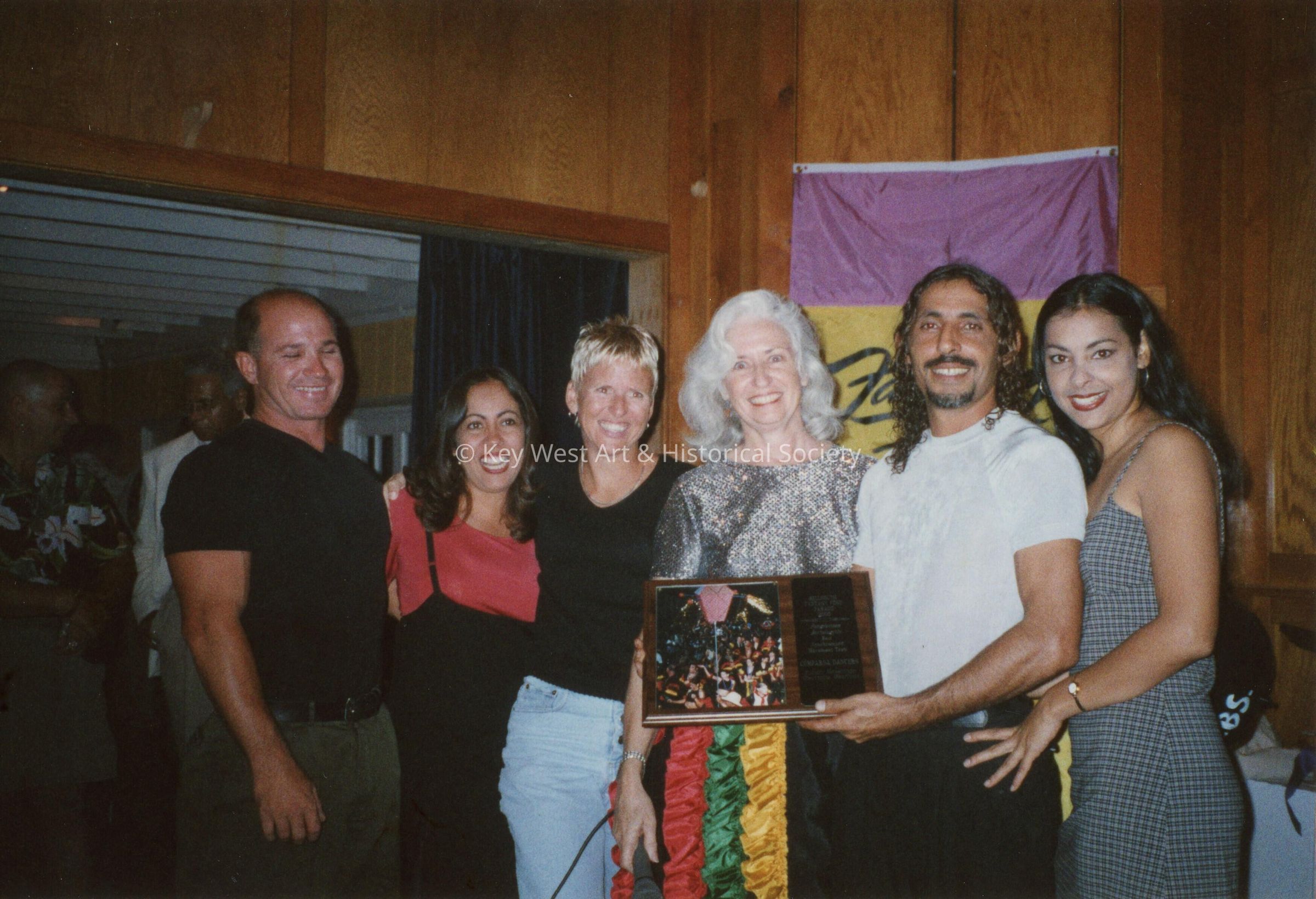 A group of unknown people at an awards ceremony.