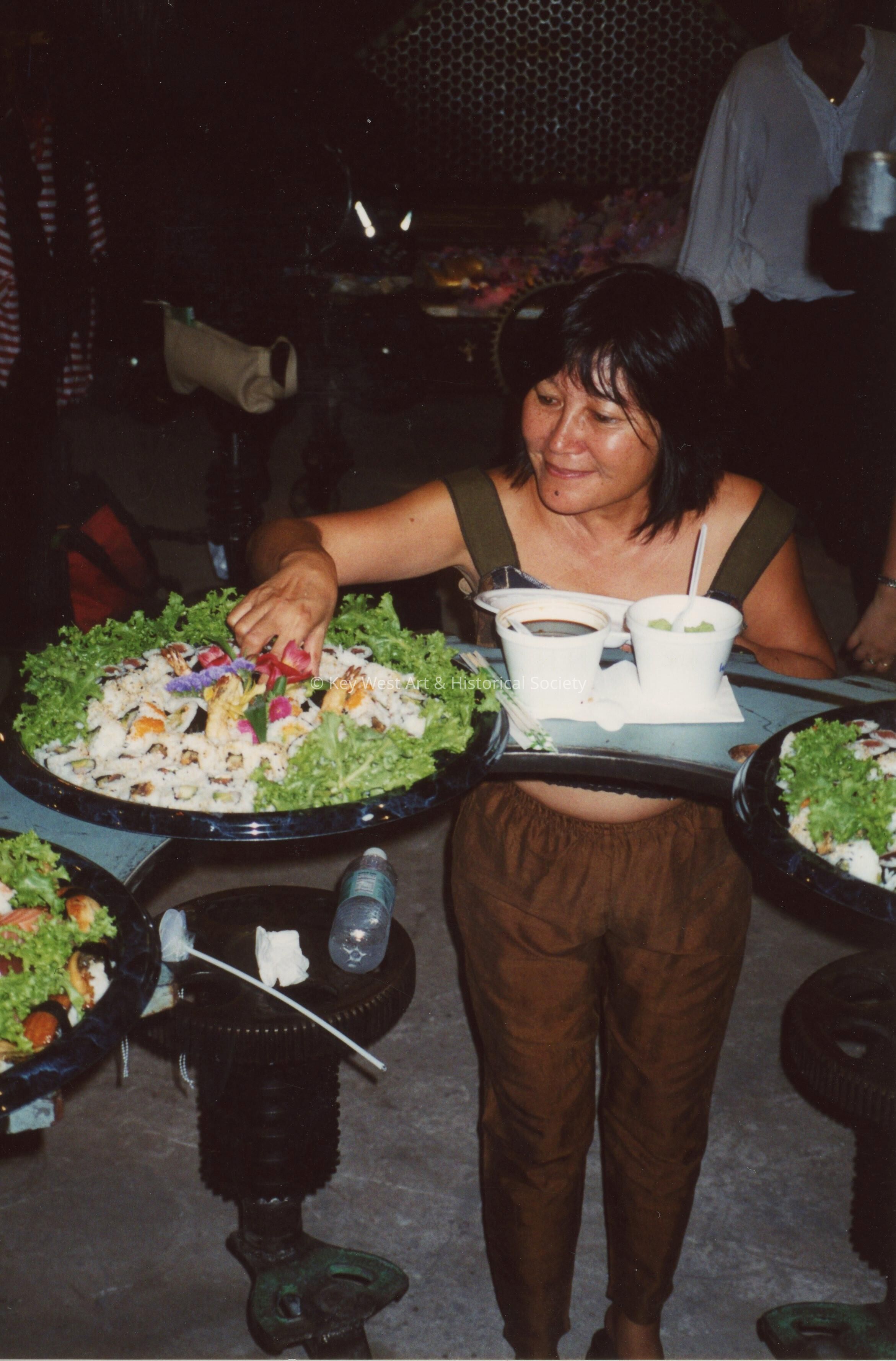 An unknown woman serving herself food.