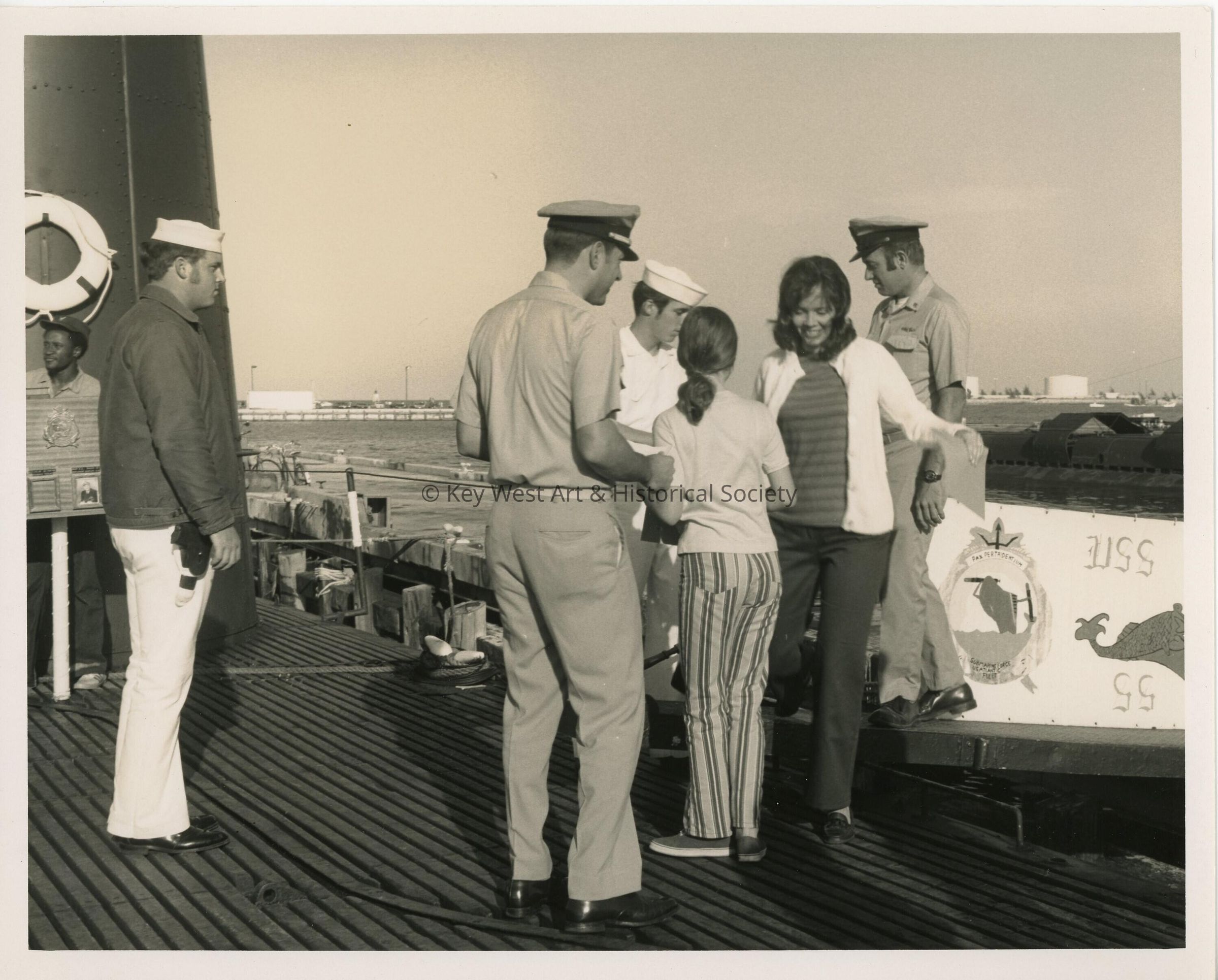 A group of unknown people standing on a ship