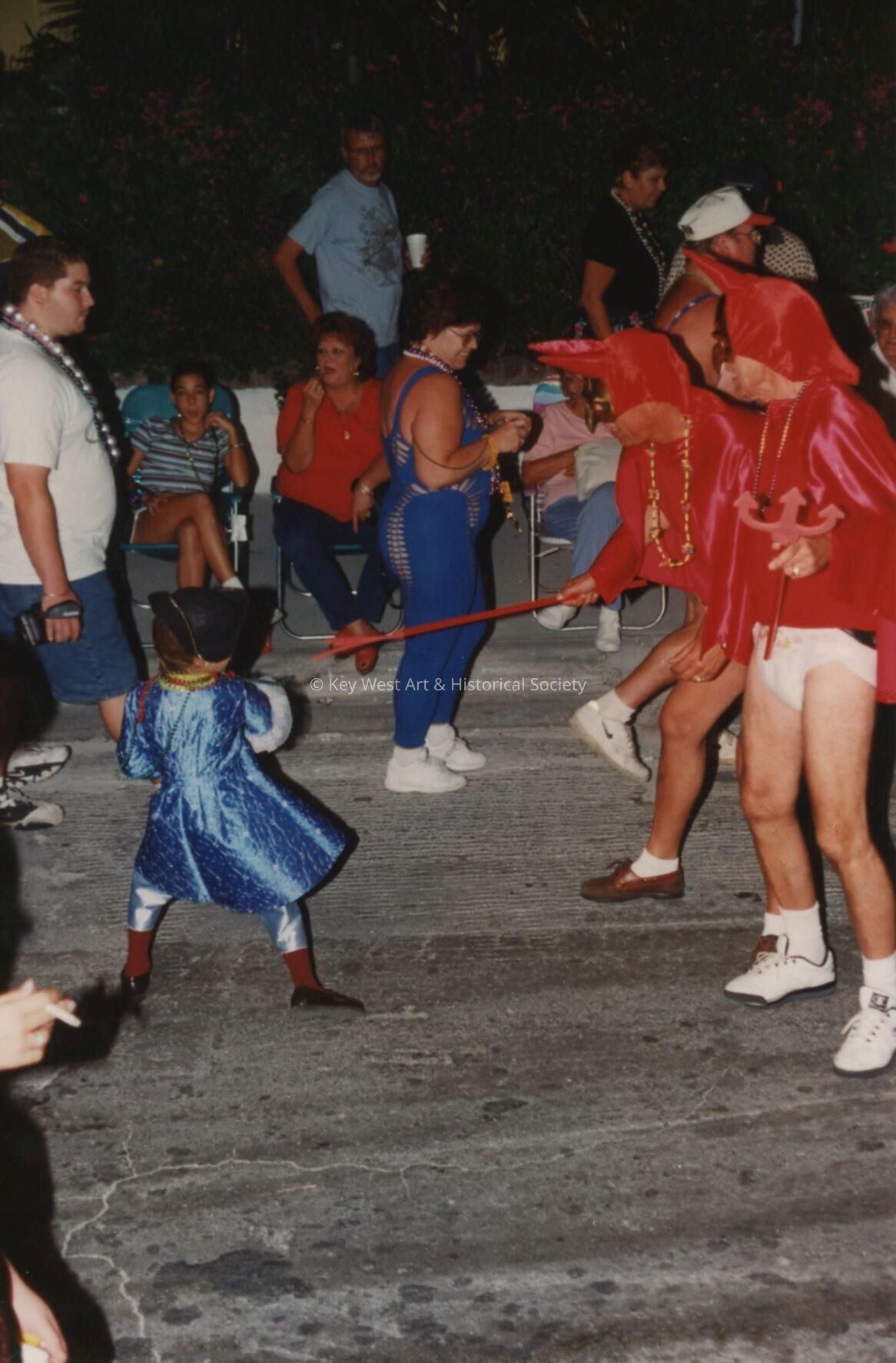 A group of unknown people, a few are dressed up.