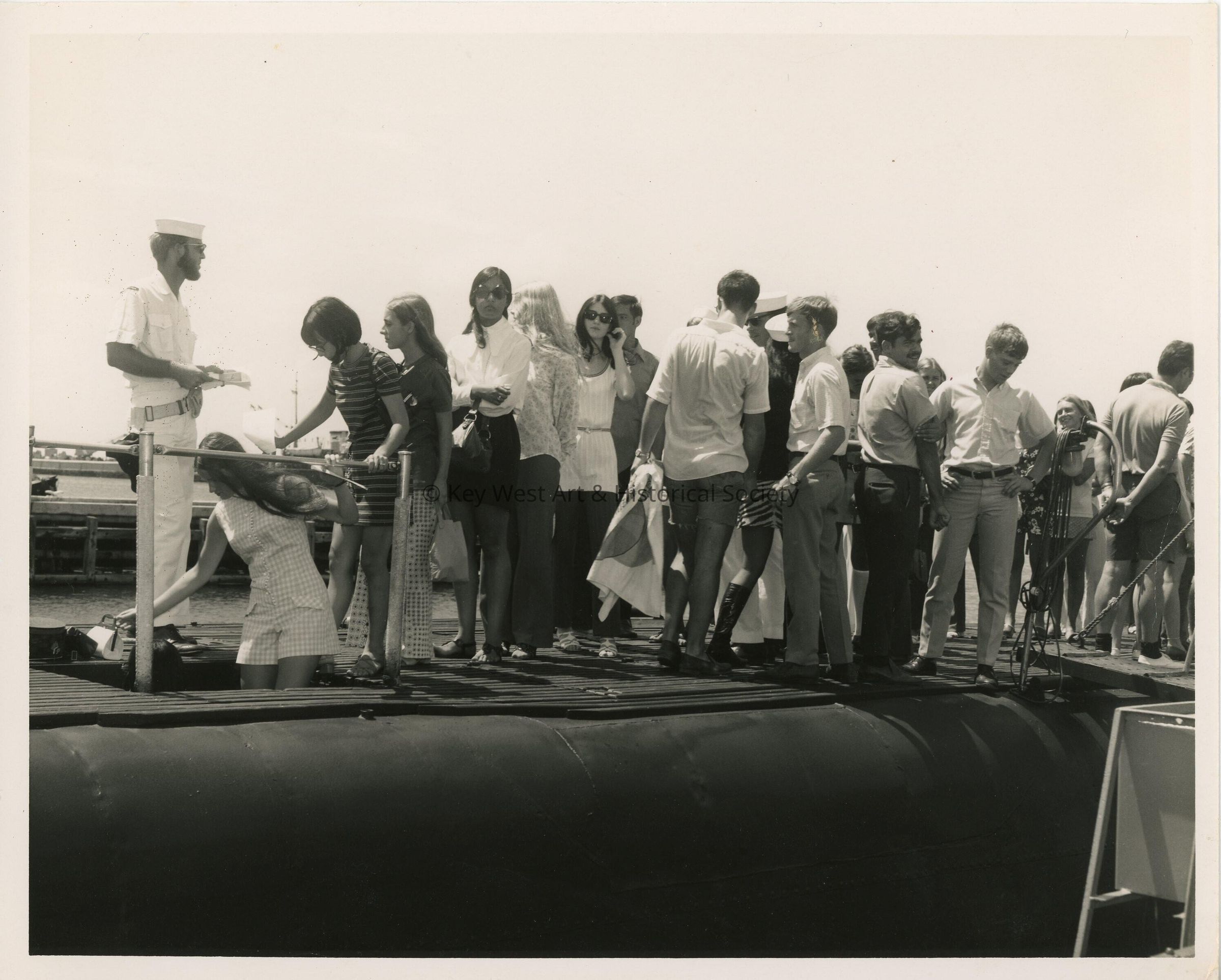 A group of unknown people standing on a ship