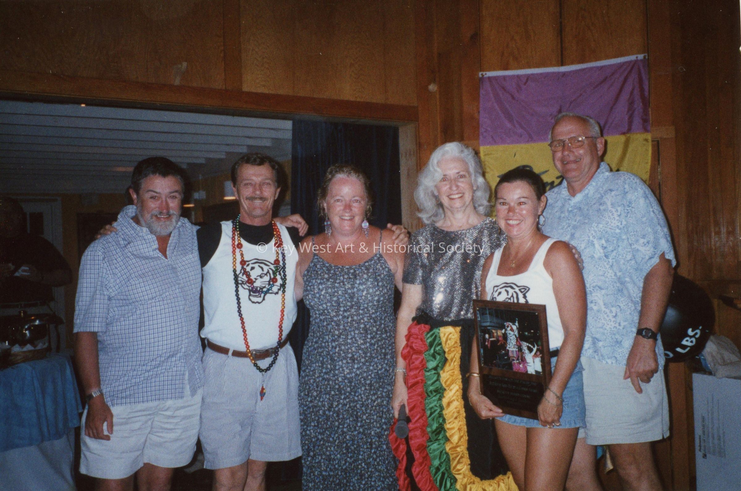 A group of unknown people at an awards ceremony.