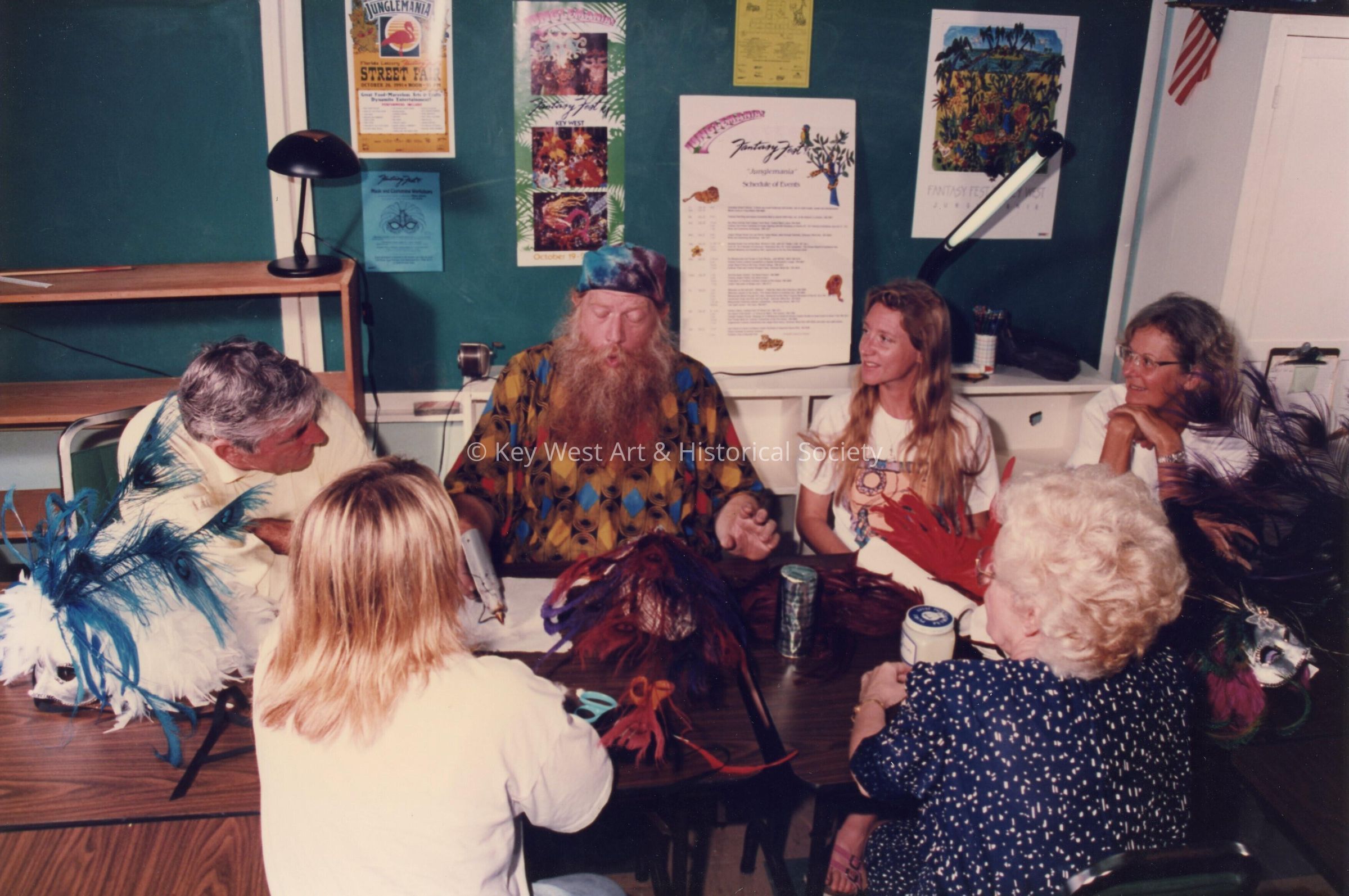 A group of unknown people sitting at a table talking.