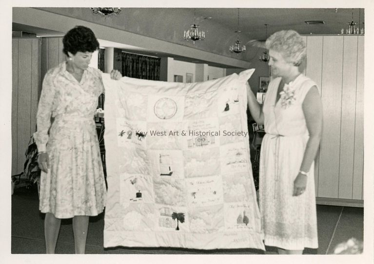 2 Unknown woman holding a quilt