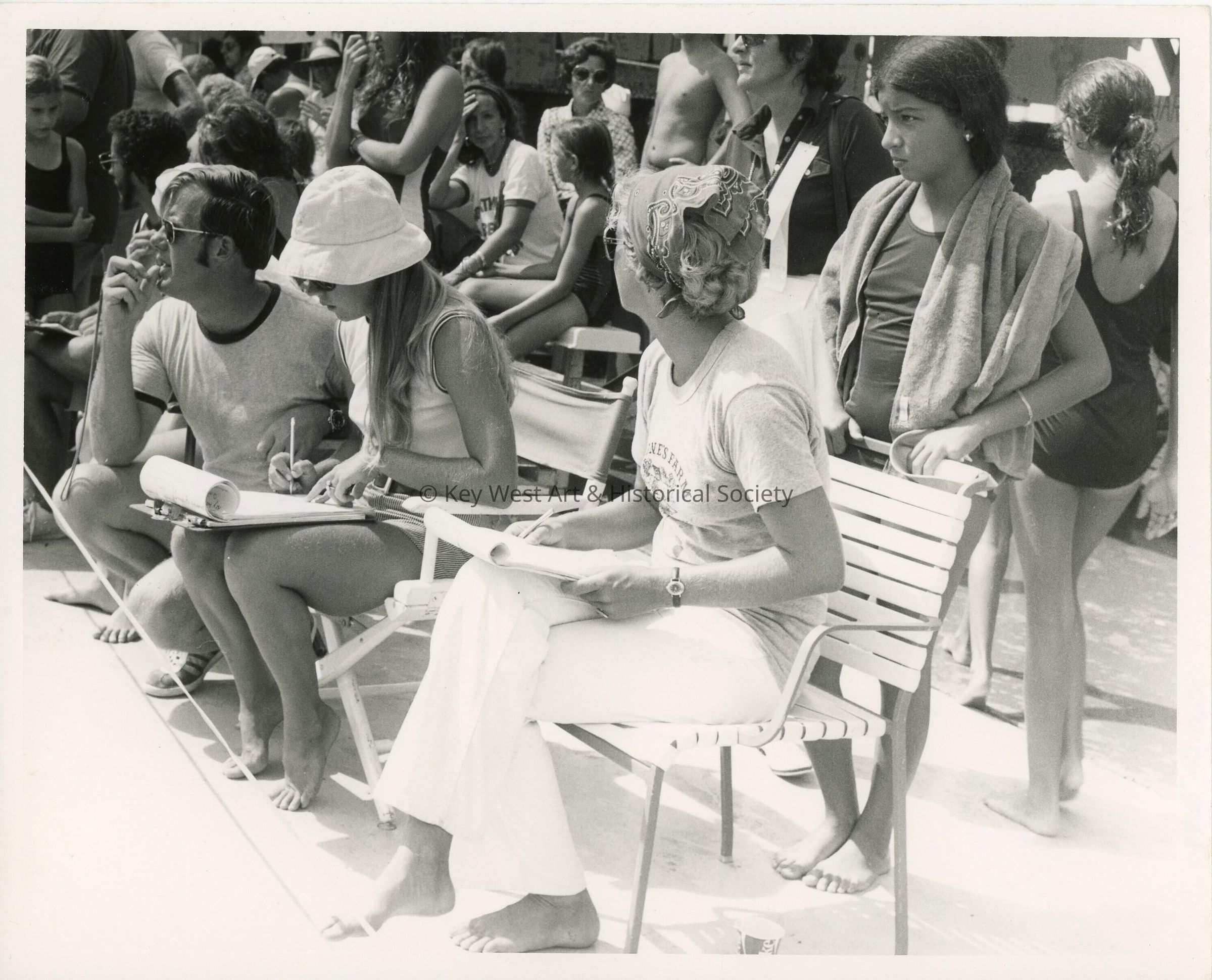 A group of unknown people at the pool