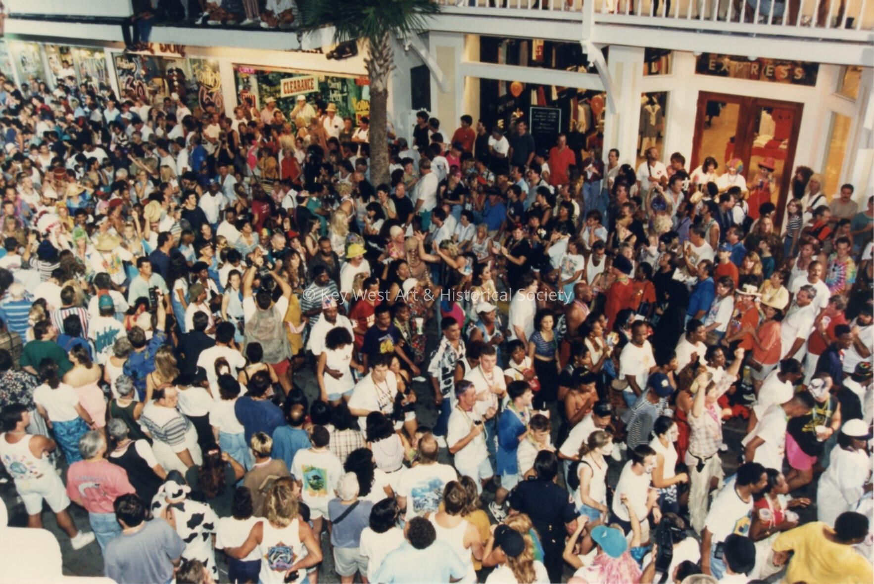 A crowd of unknown people on Duval street near La Conch and the Express sto