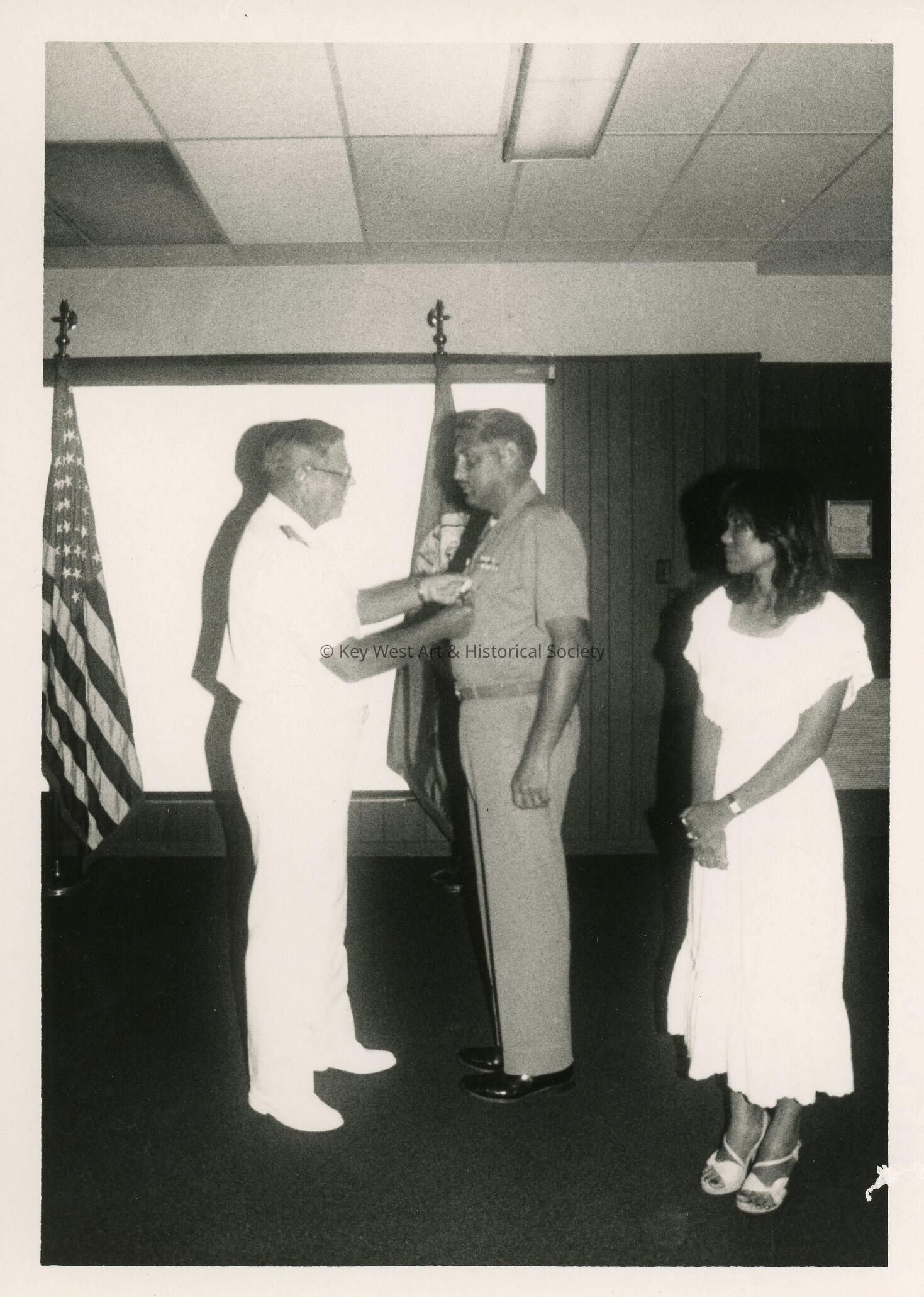3 Unknown people at a ceremony