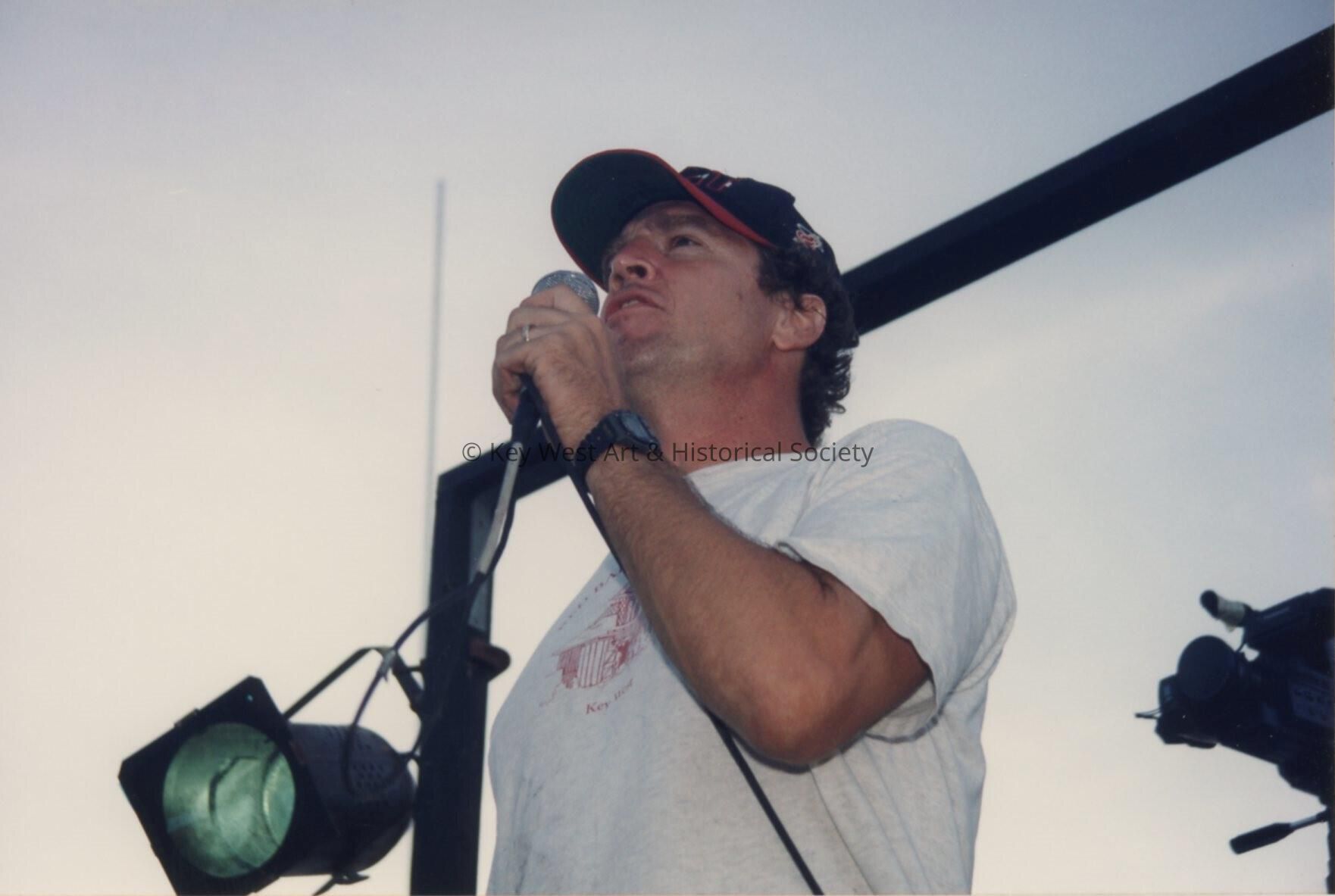 An unknown man talking.
