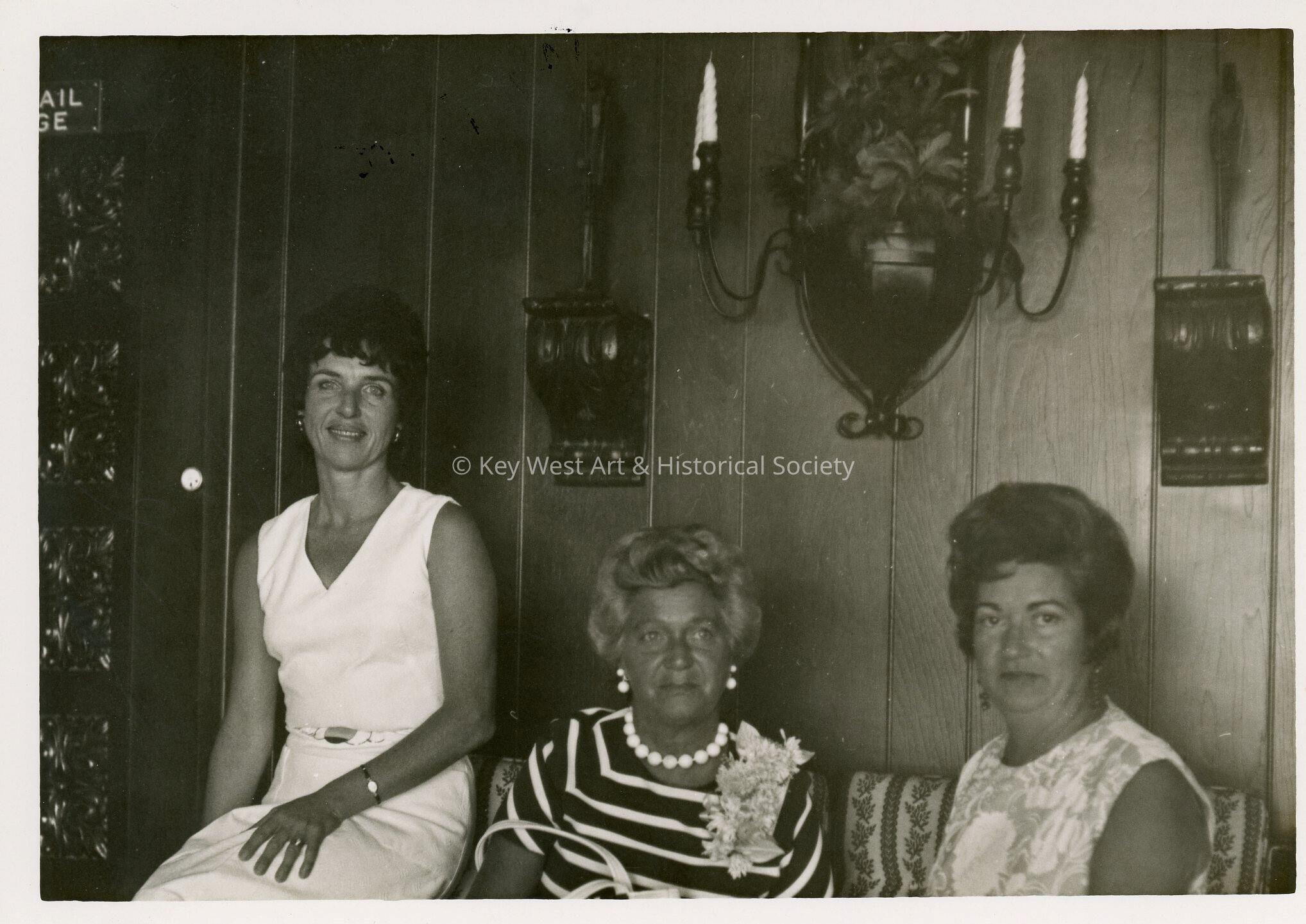 3 Unknown woman sitting in a living room