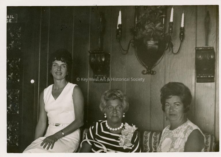 3 Unknown woman sitting in a living room