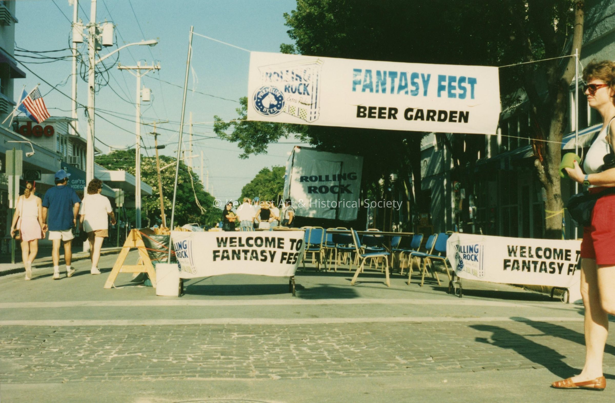 An area on the street set up with a banner that says FF beer garden.