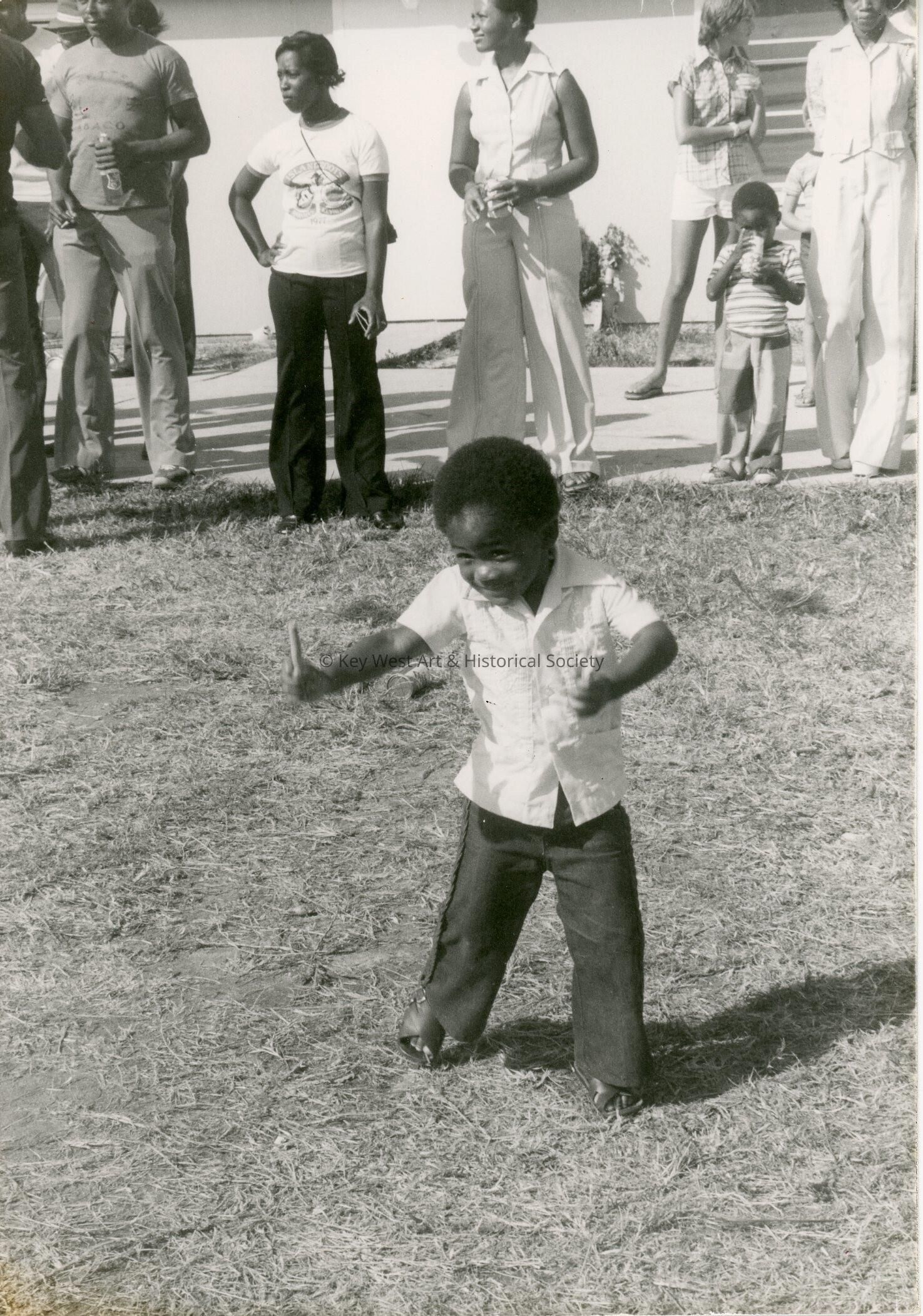 An unknown child dancing outside
