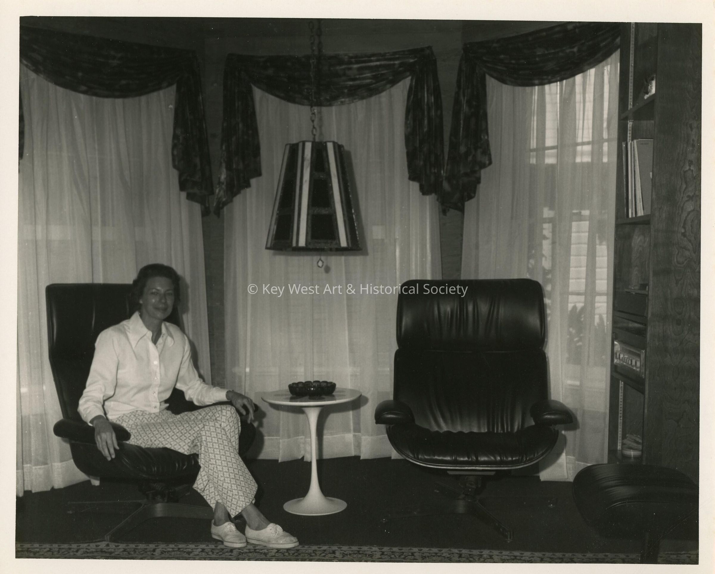 An unknown woman sitting in a living room