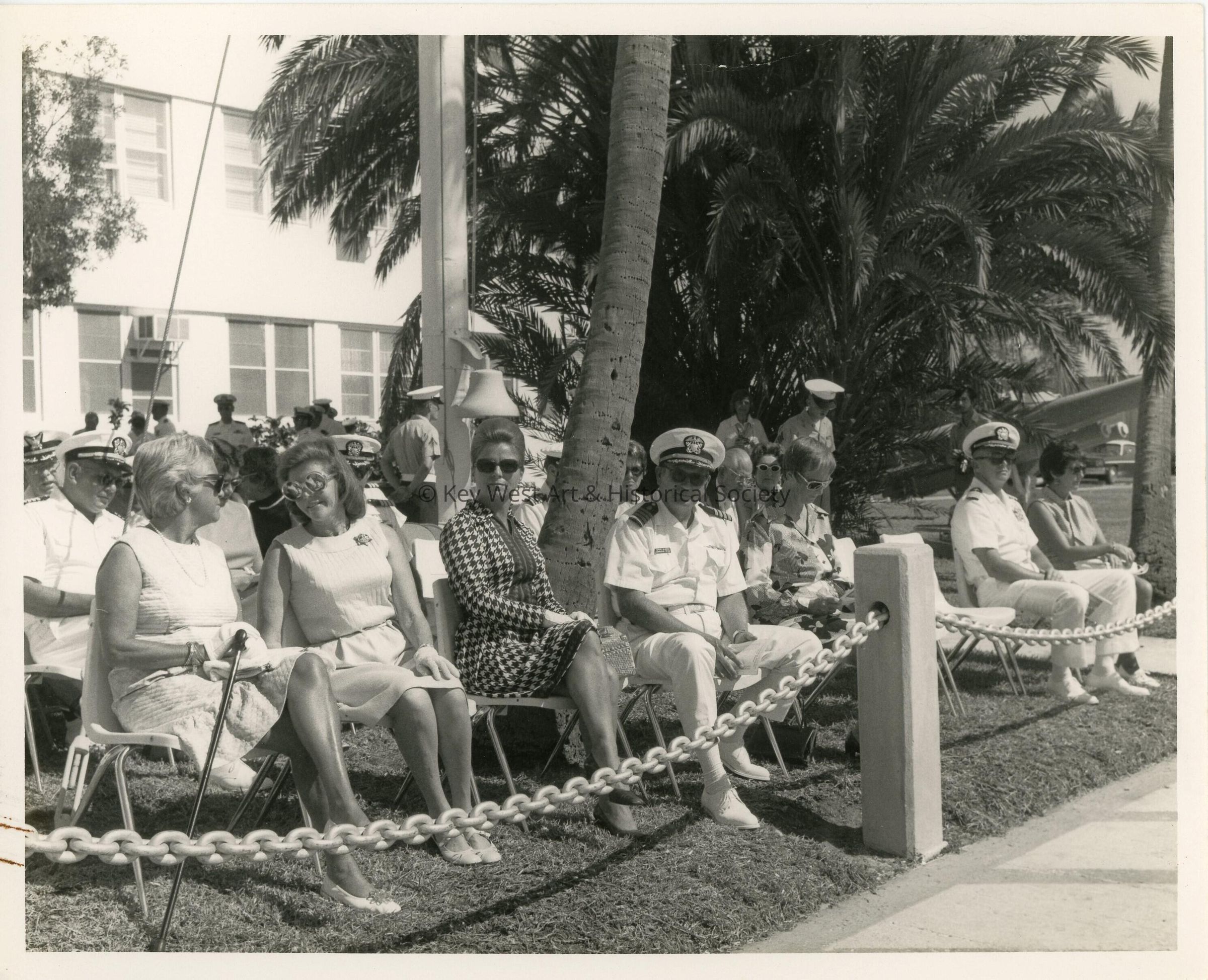 A group of unknown people sitting at a ceremony