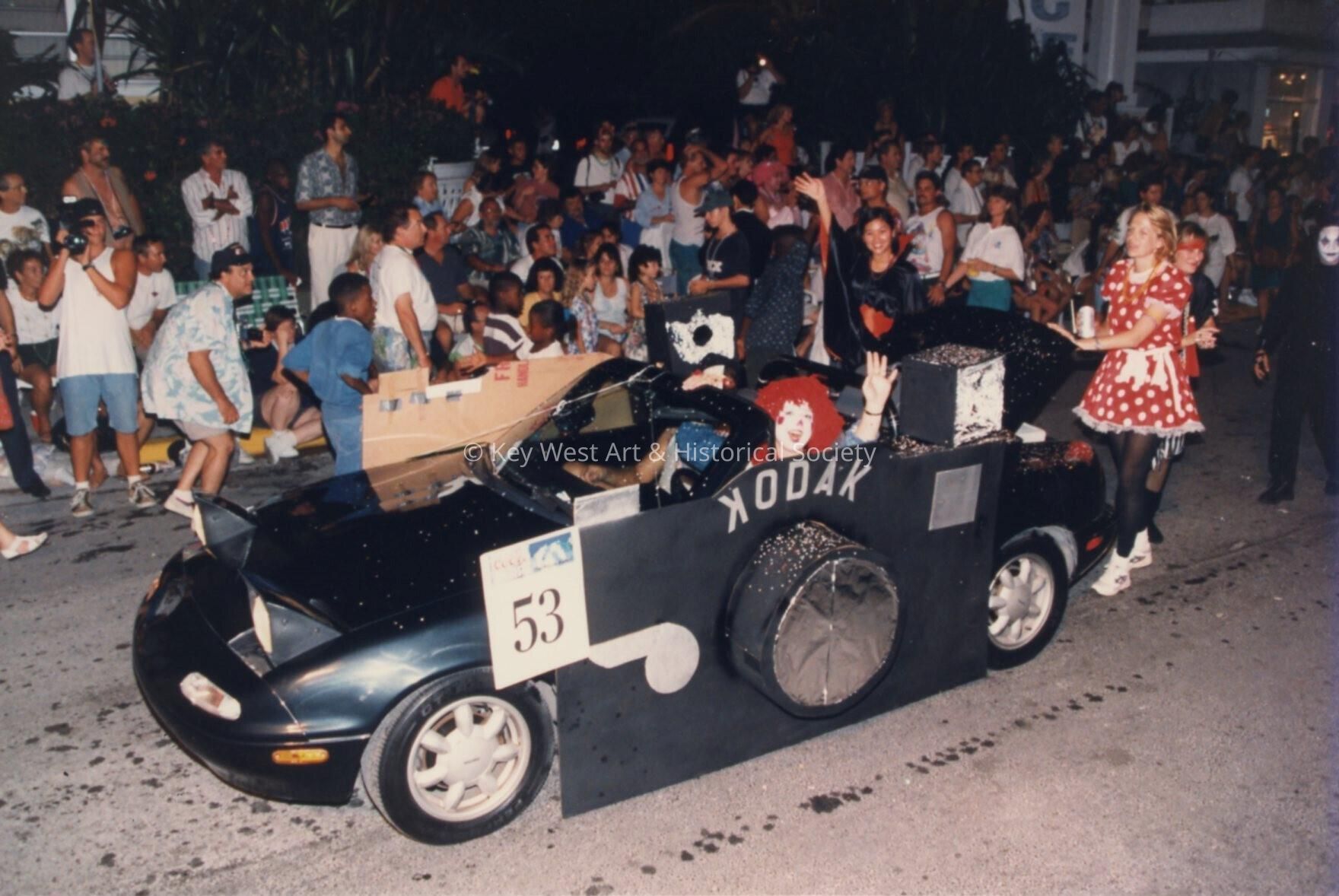 A car as a camera, float number 53 in the parade.