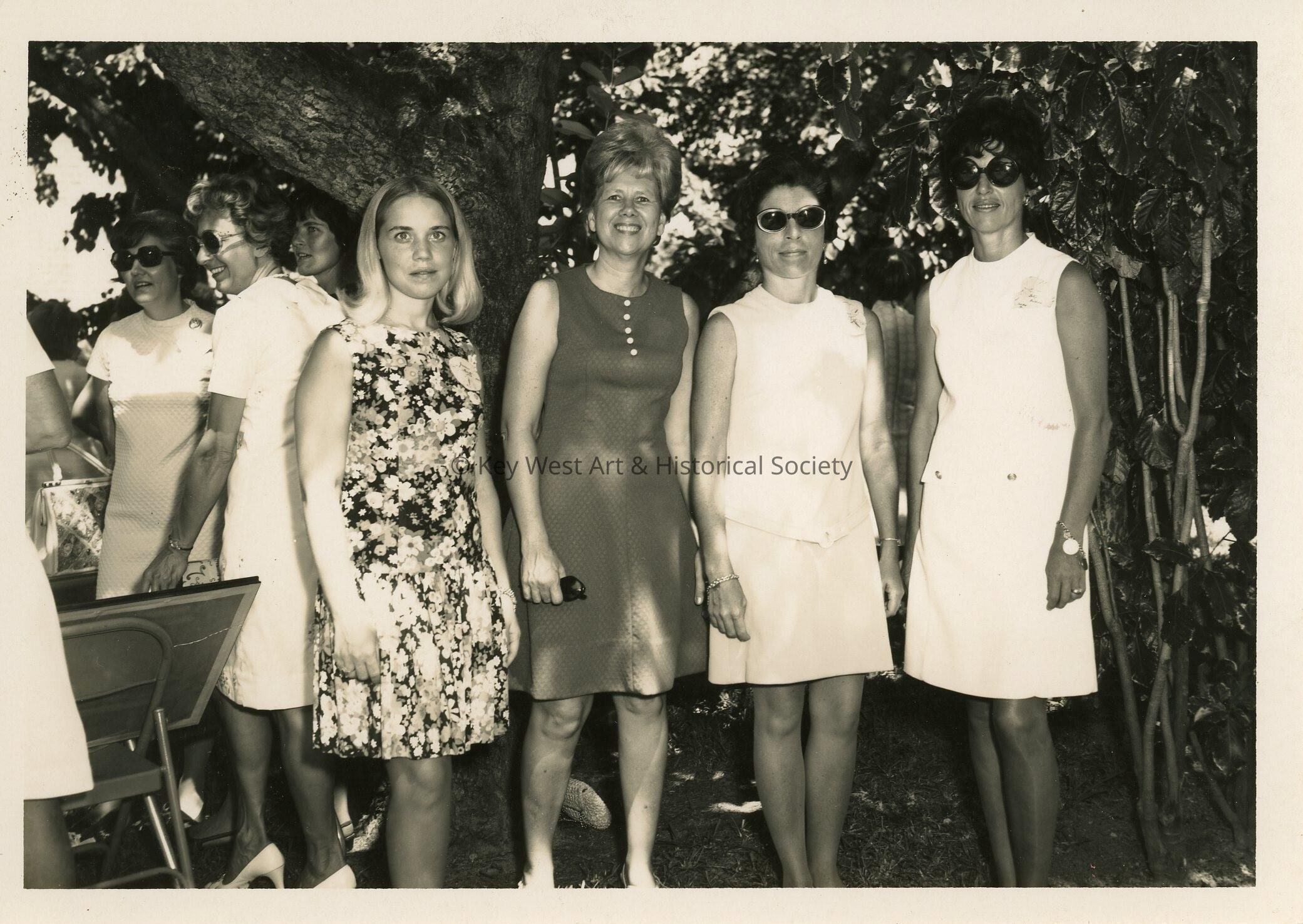 A group of woman standing outside