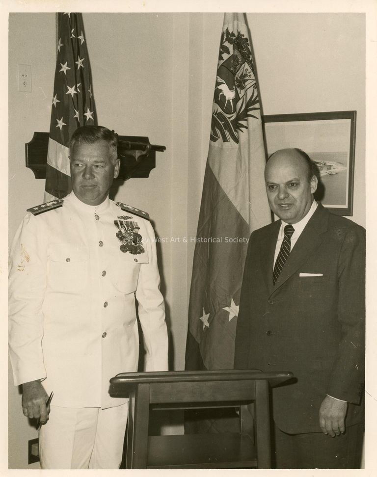 2 Men standing next to a podium