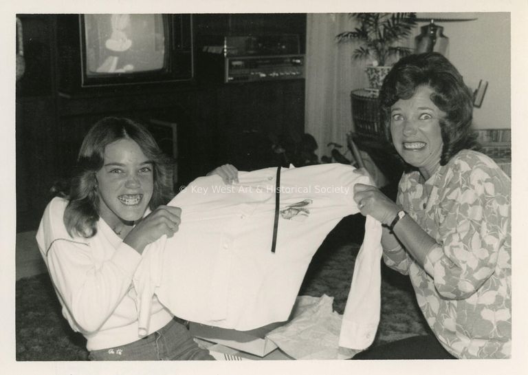 2 Woman pulling on a shirt