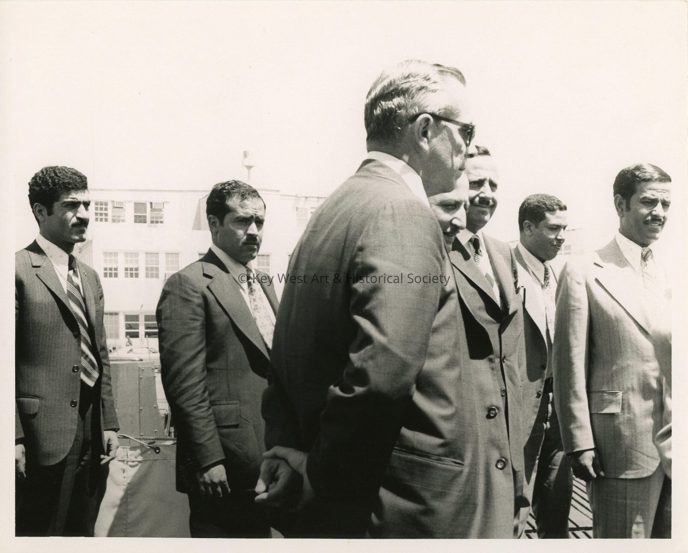 A group of men in suits standing