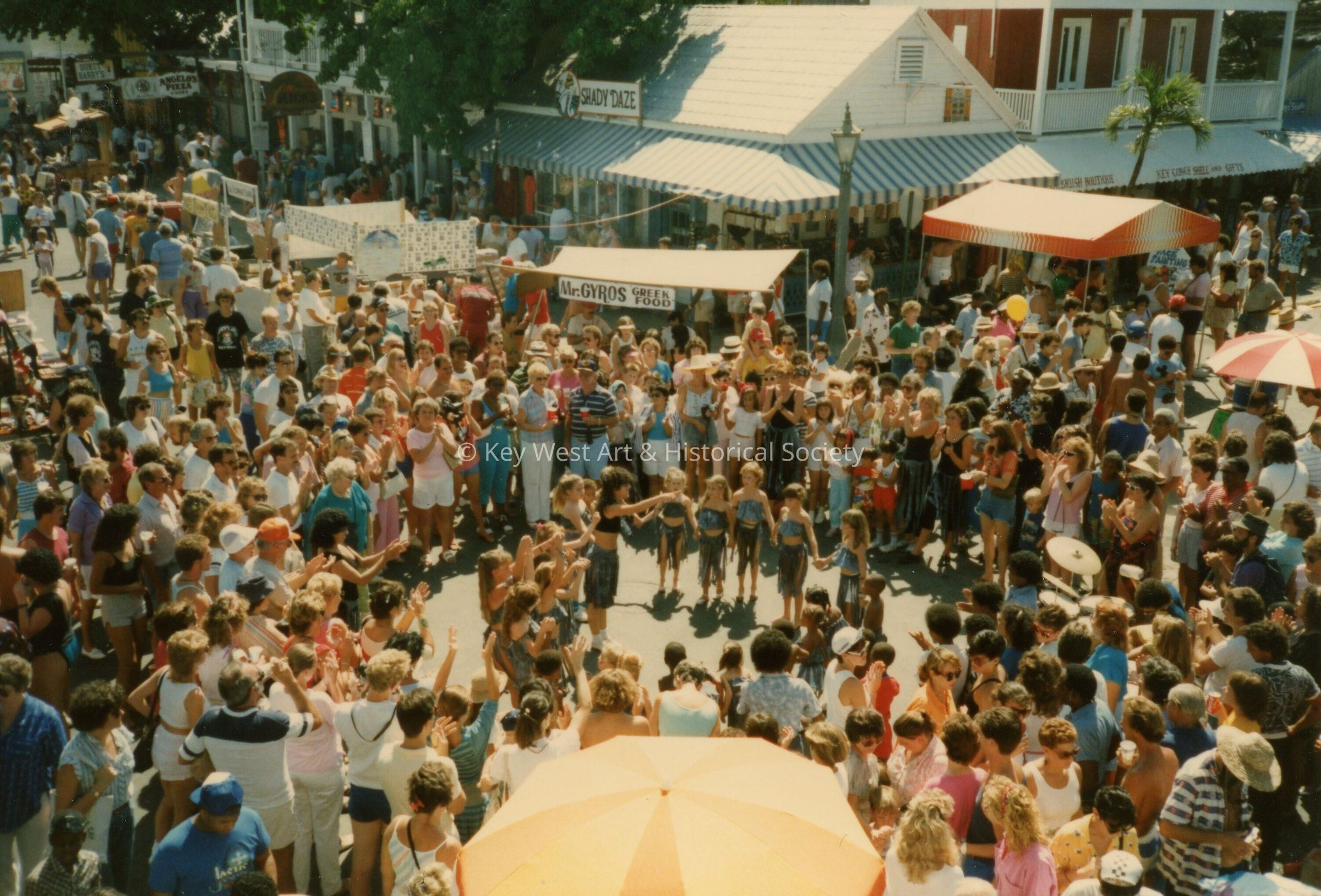 A huge group of unknown  people standing on Duval and Green Street.