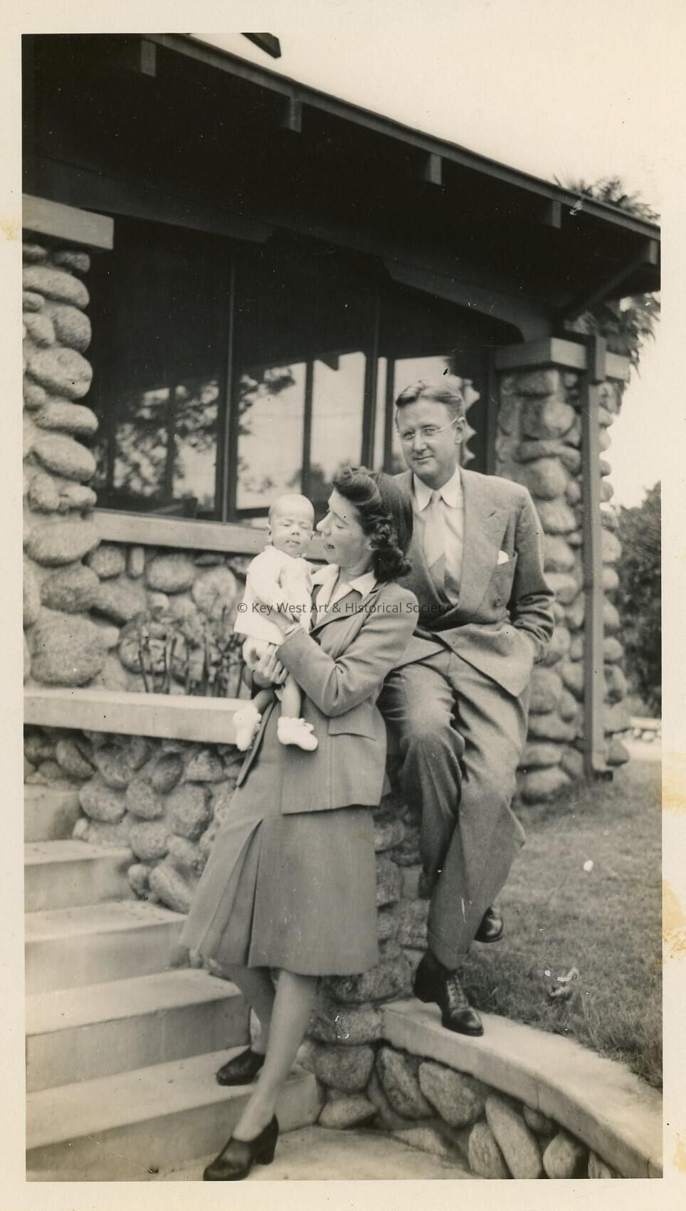 An unknown couple with a baby