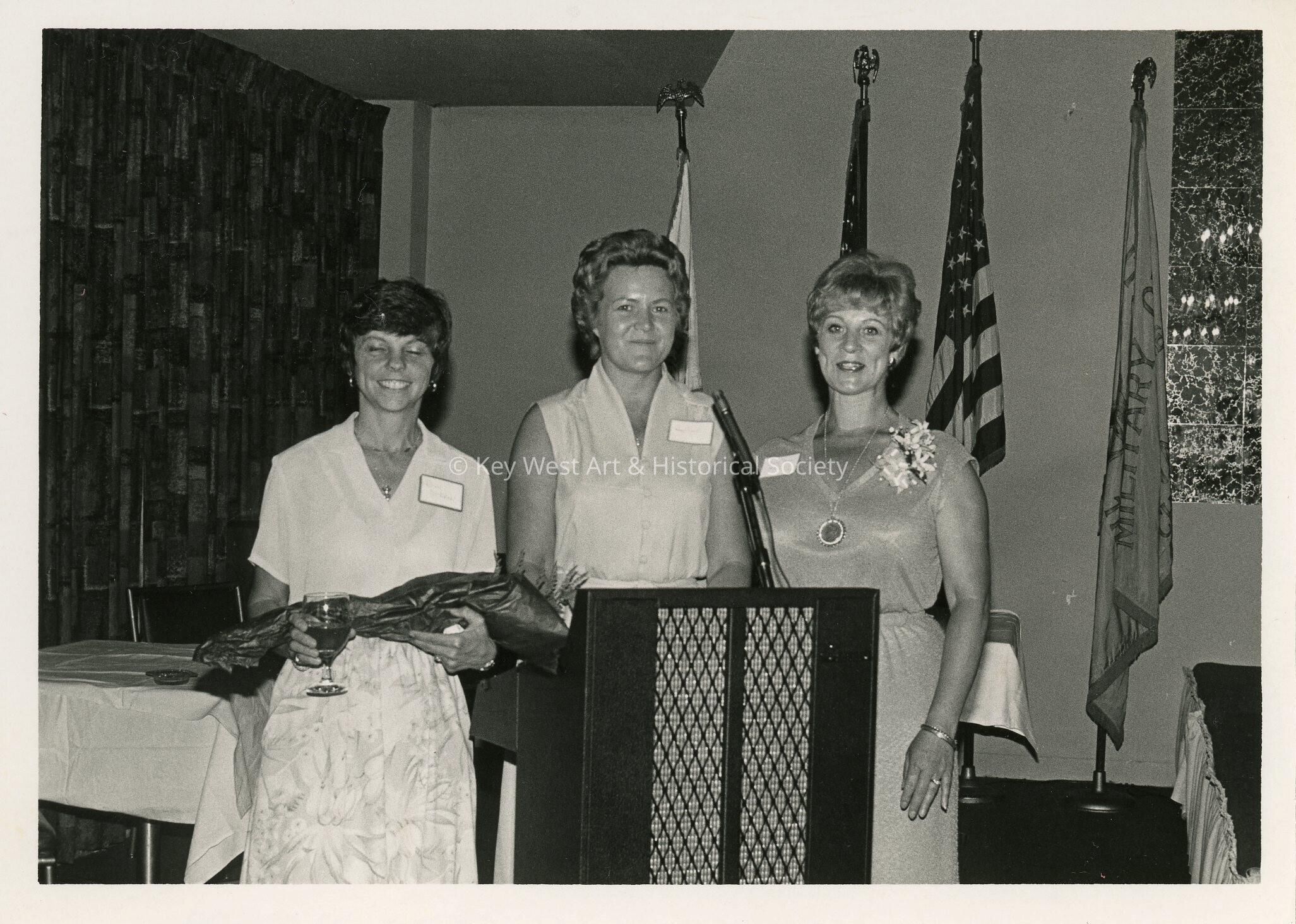 3 Unknown woman standing at a podium