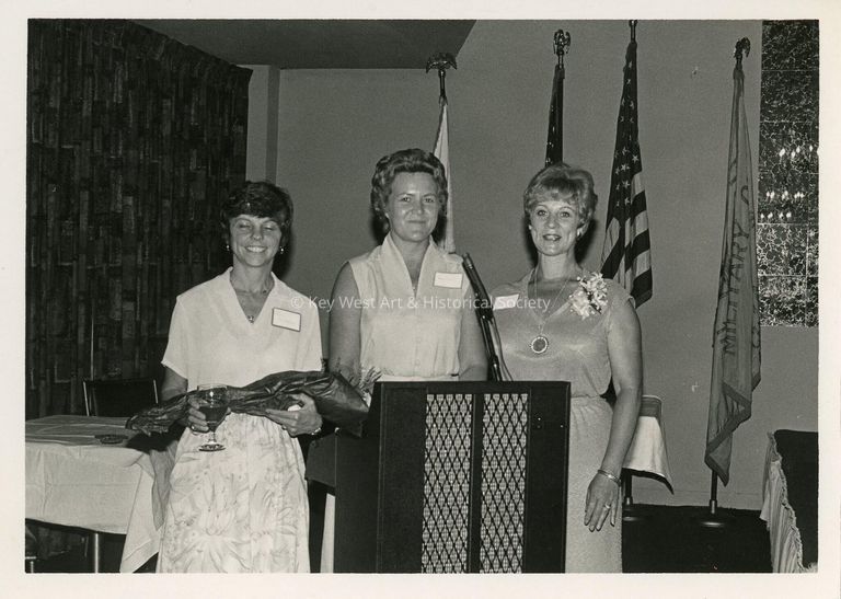 3 Unknown woman standing at a podium