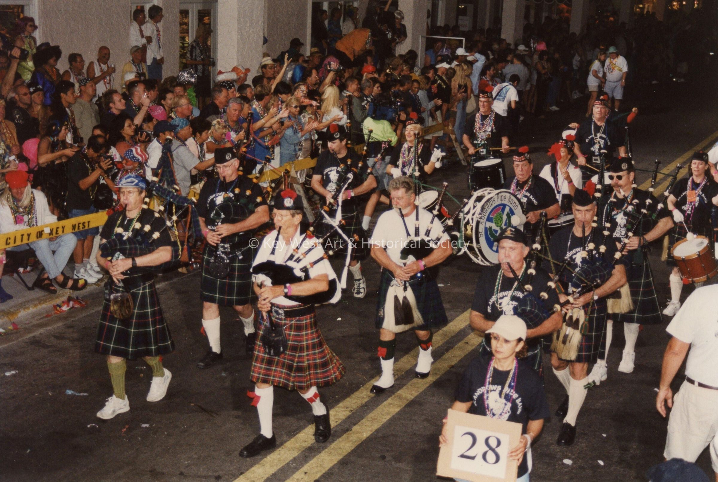 An unknown group of people playing in a band in the parade.