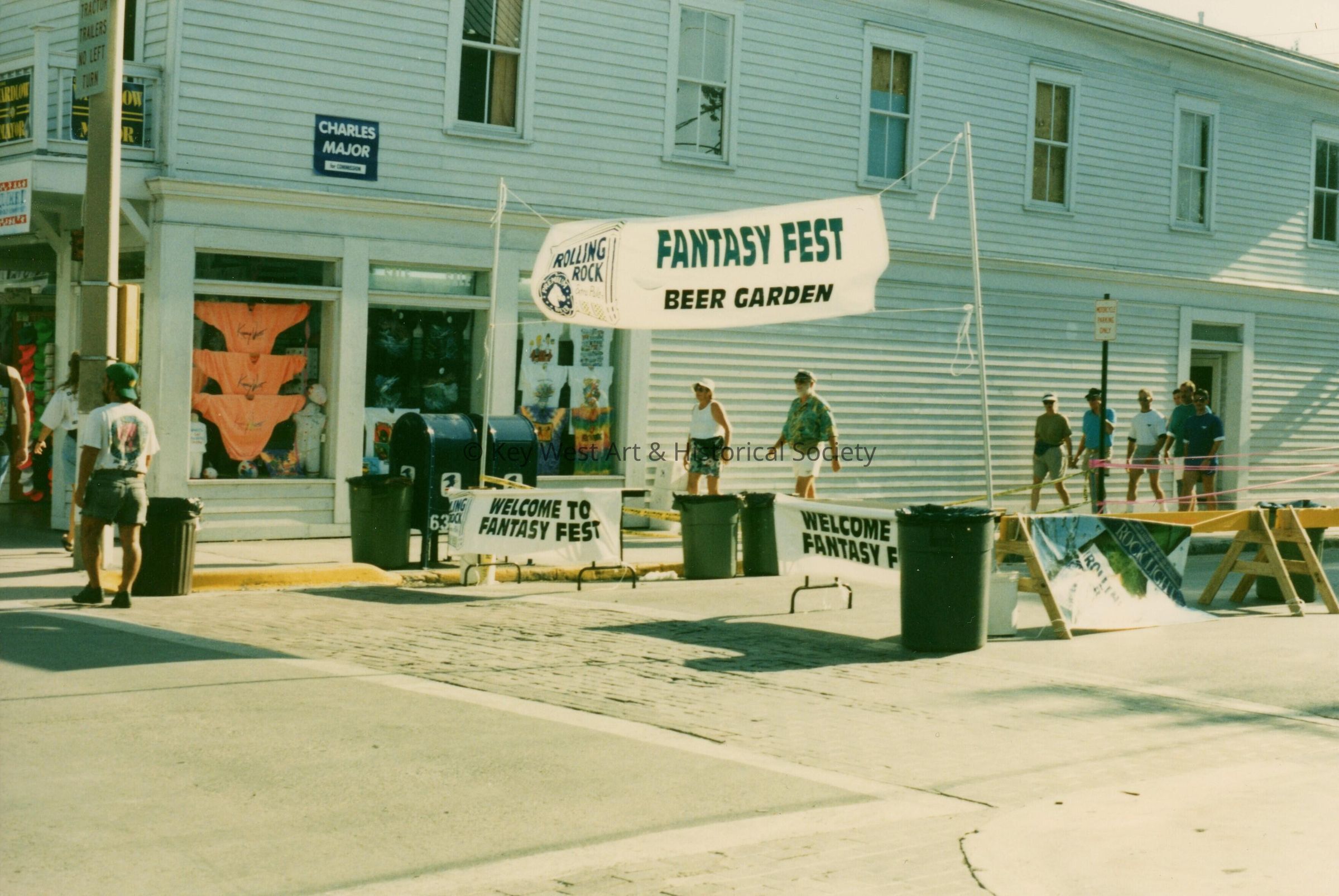 An area on the street set up with a banner that says FF beer garden.