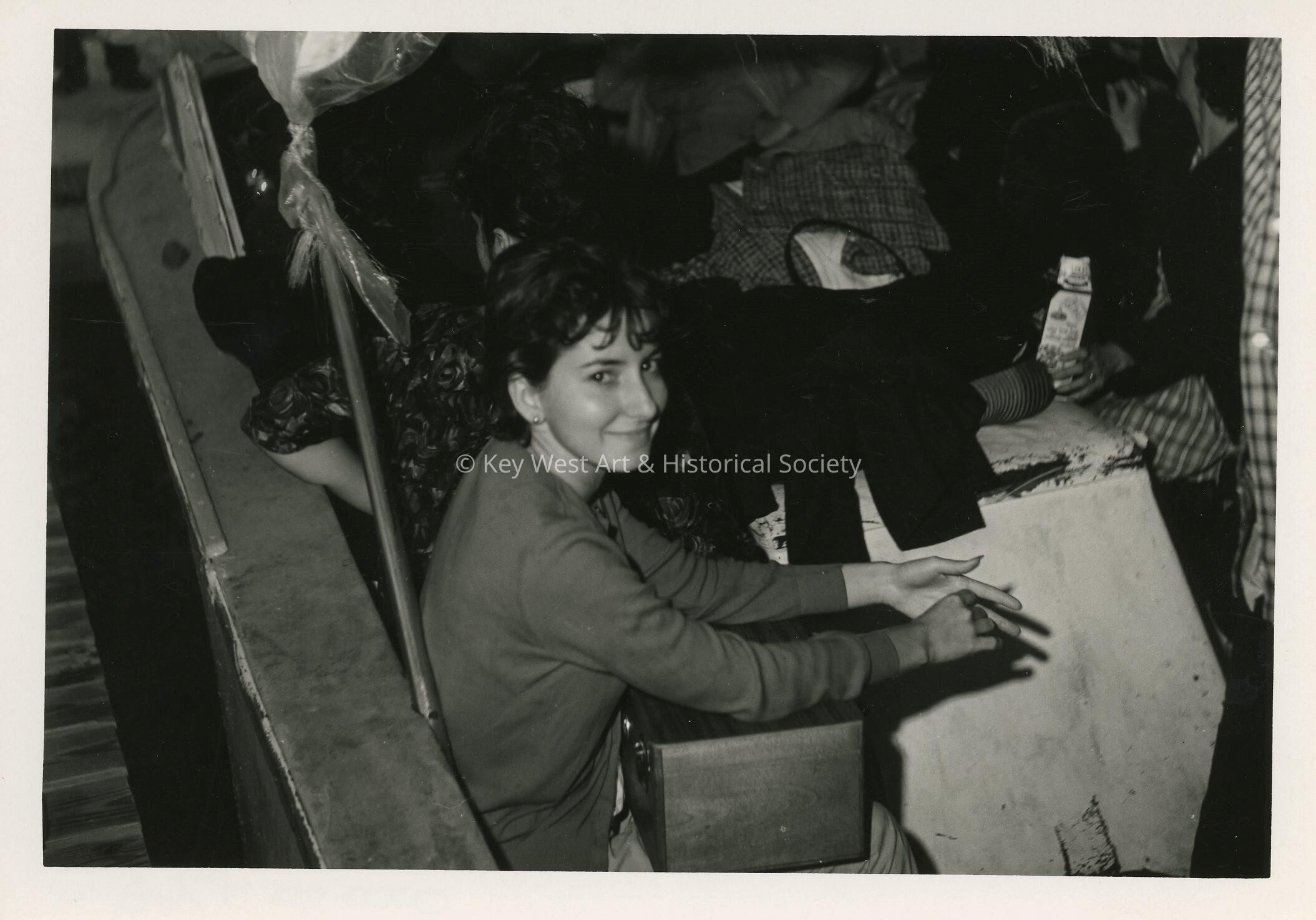 An unknown girl sitting with others around her