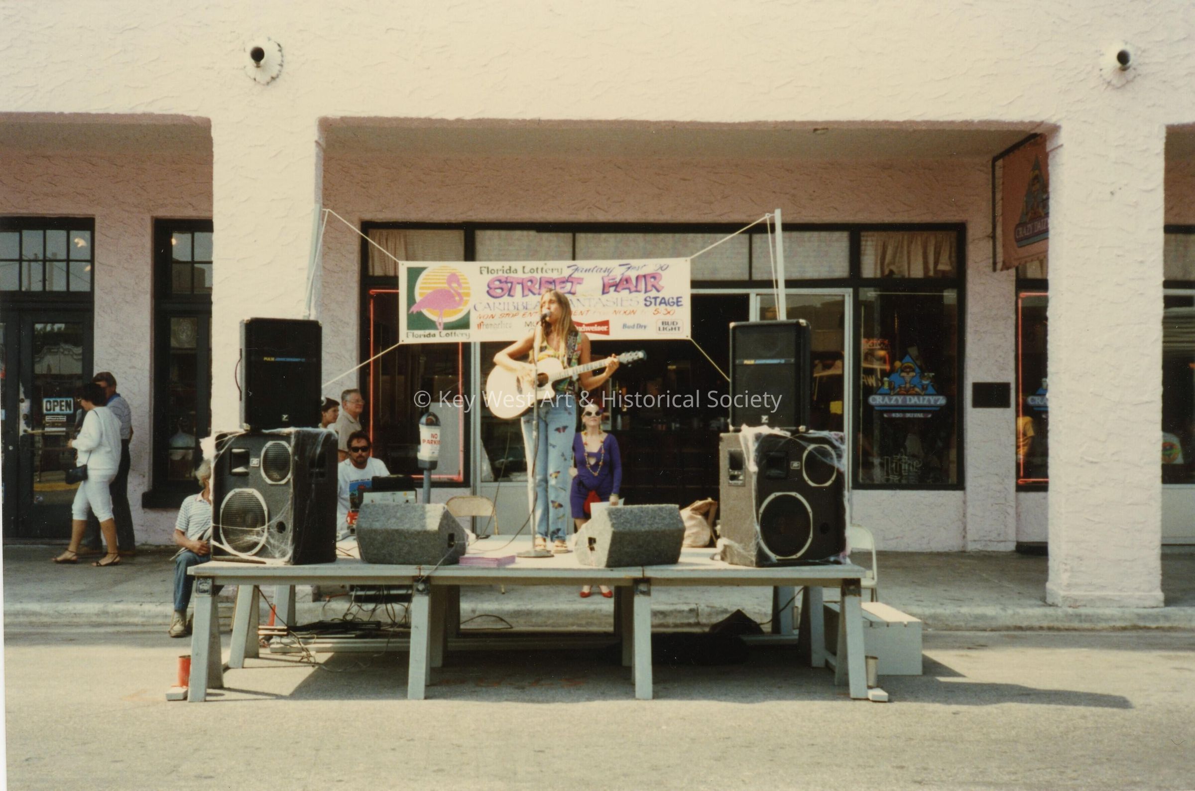 A stage in front of La Concha, with an unknown person singing.