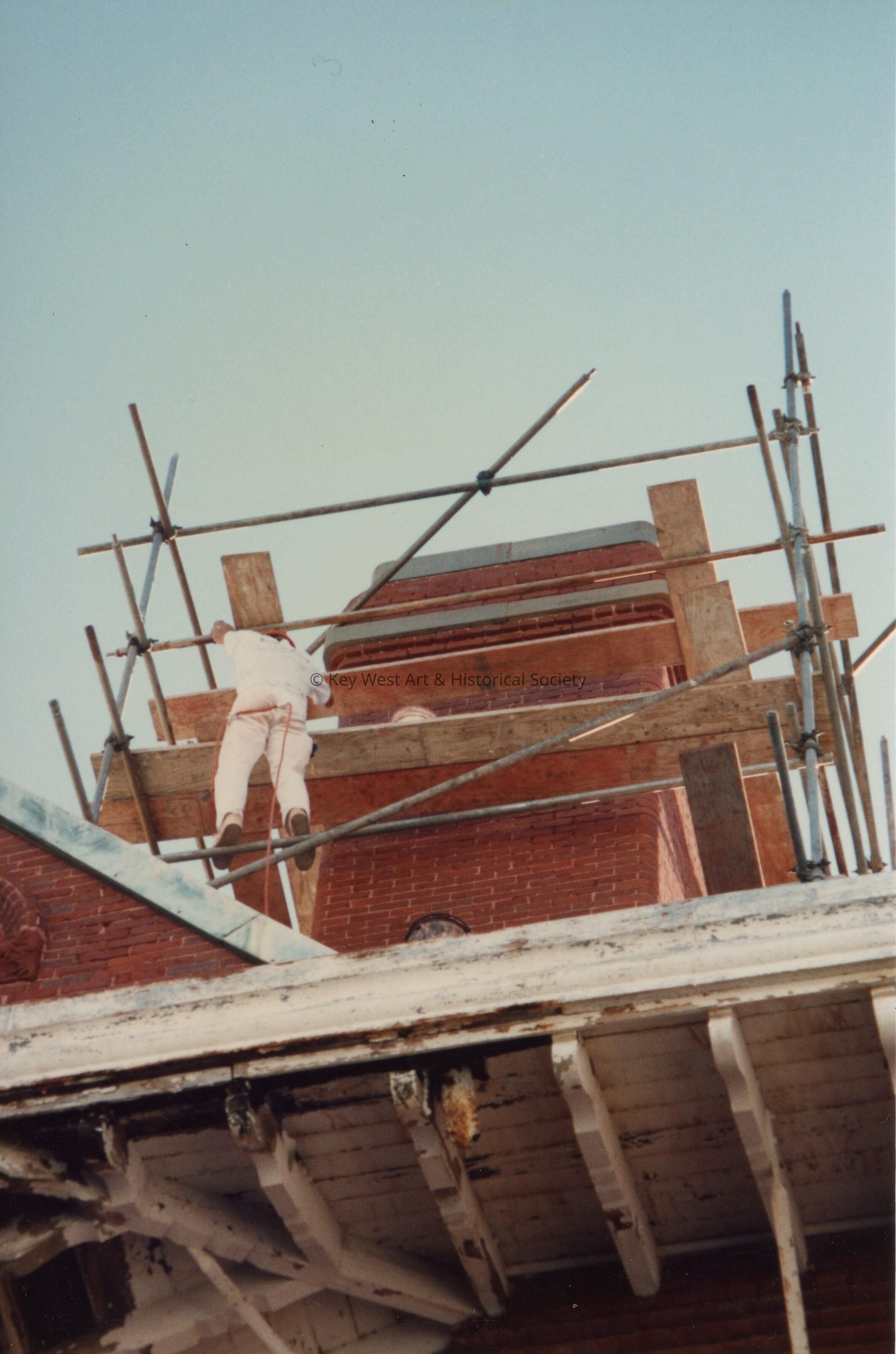 An unknown man working on one of the Chimney's.