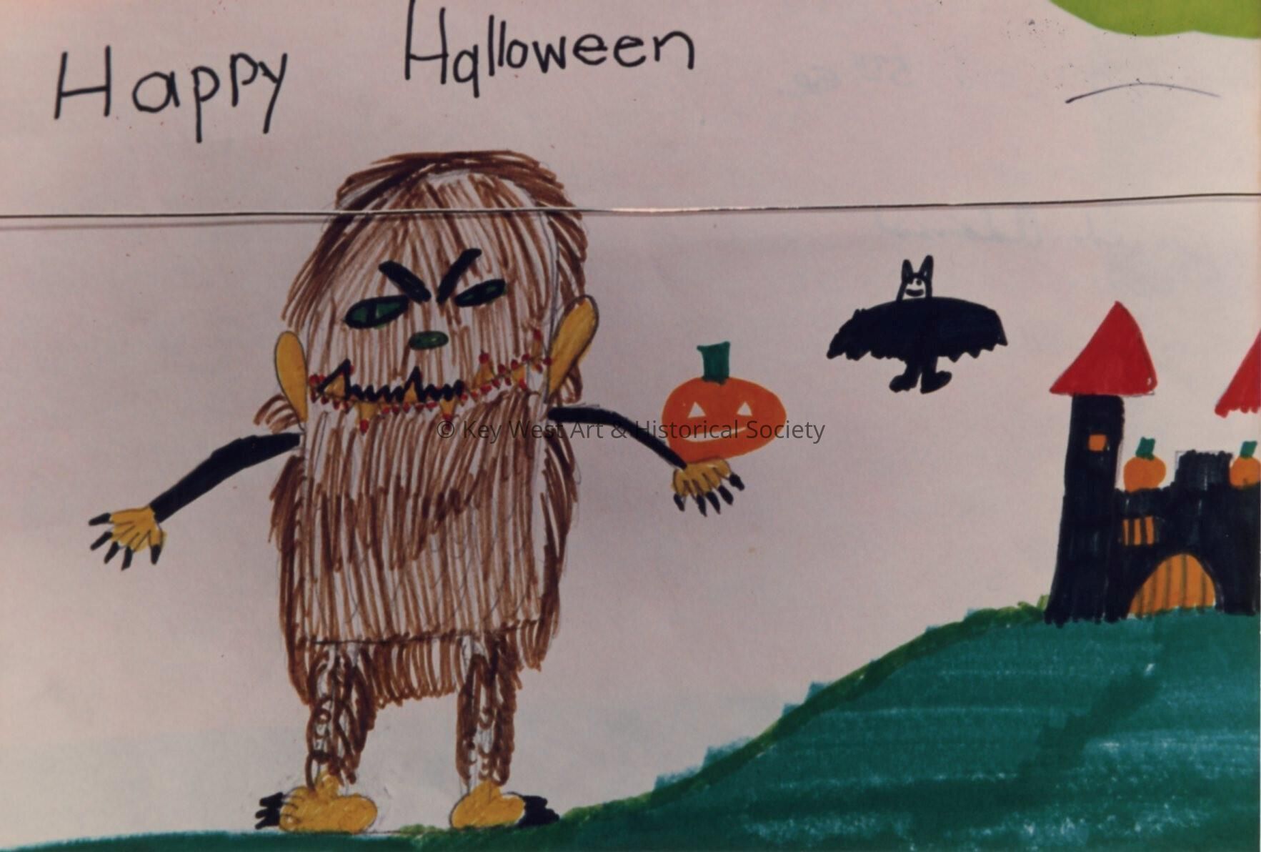 A drawing that a school child did that says Happy Halloween.