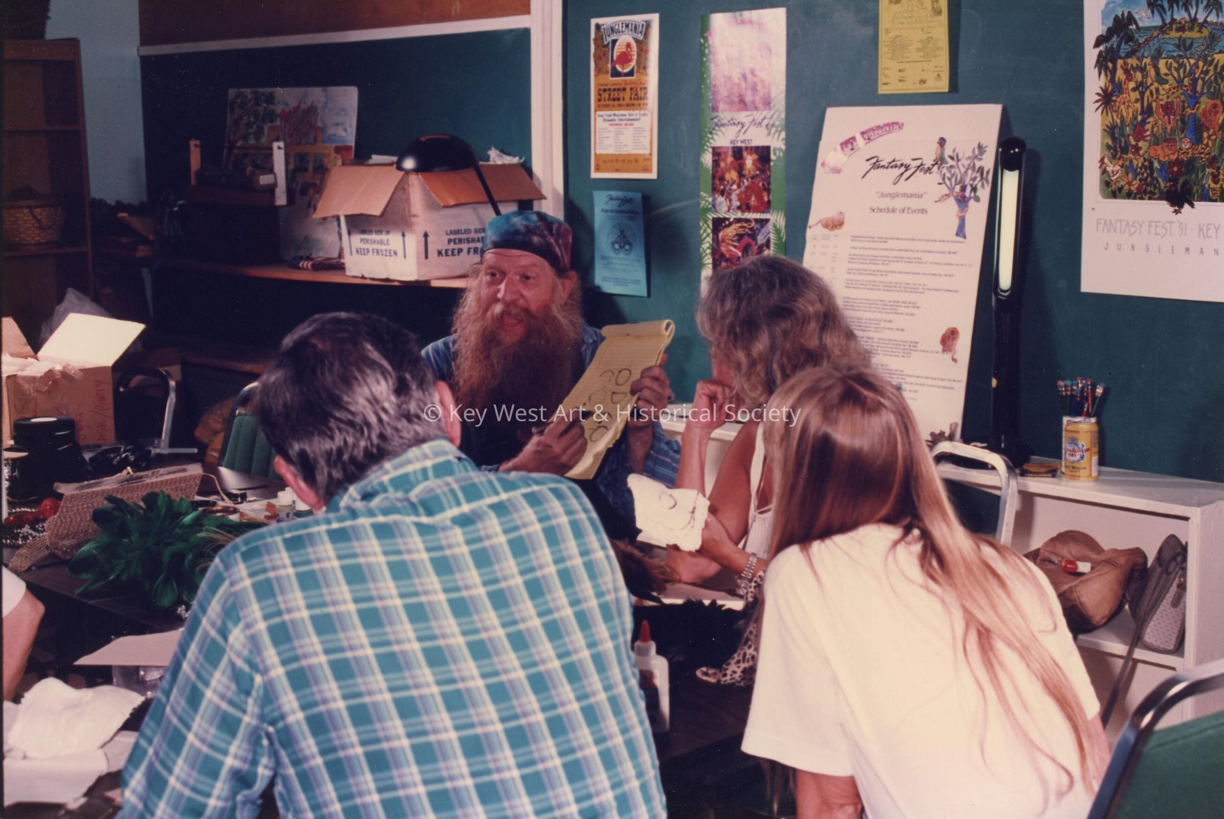 A group of unknown people sitting at a table talking.