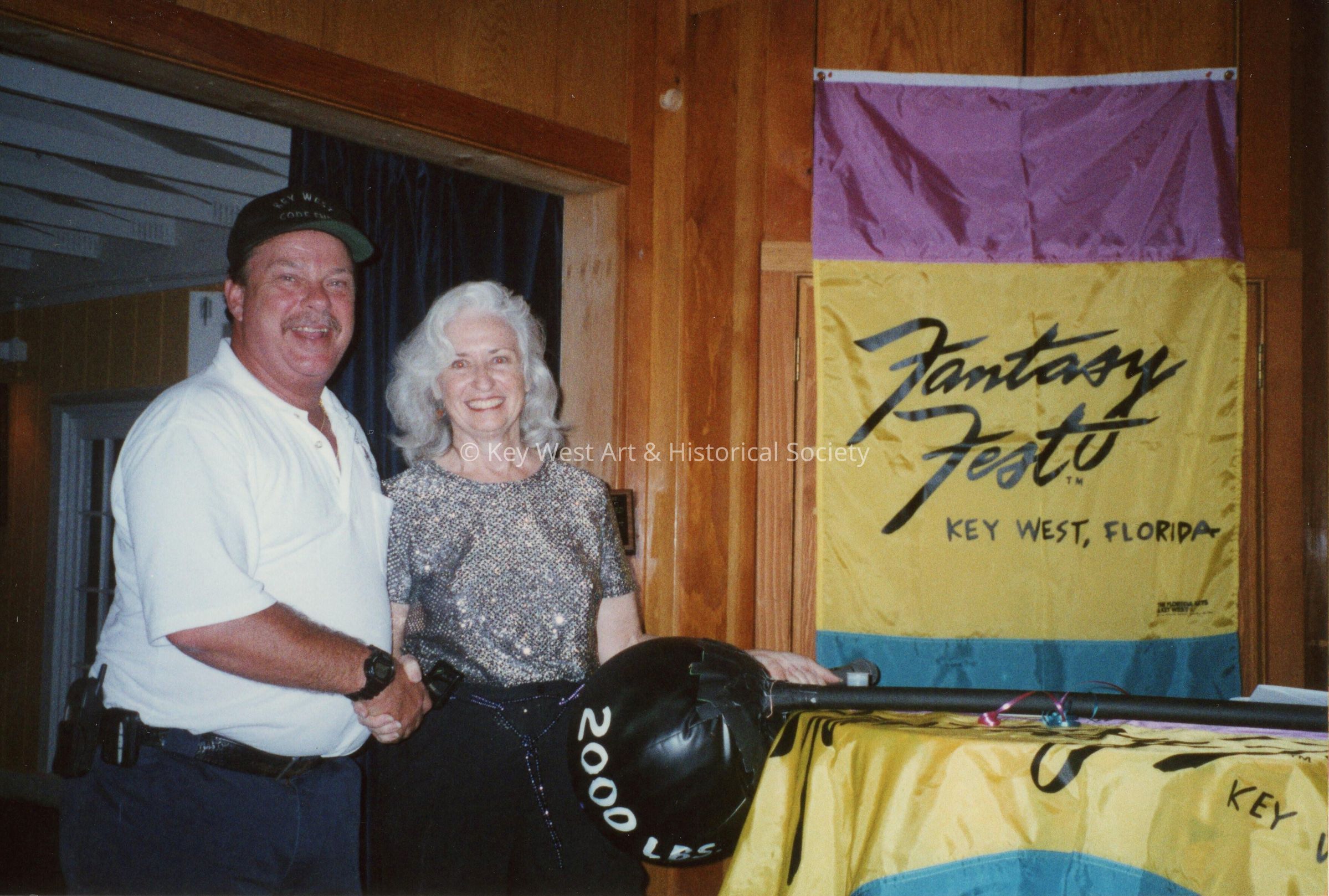 An unknown woman and man at an award ceremony.