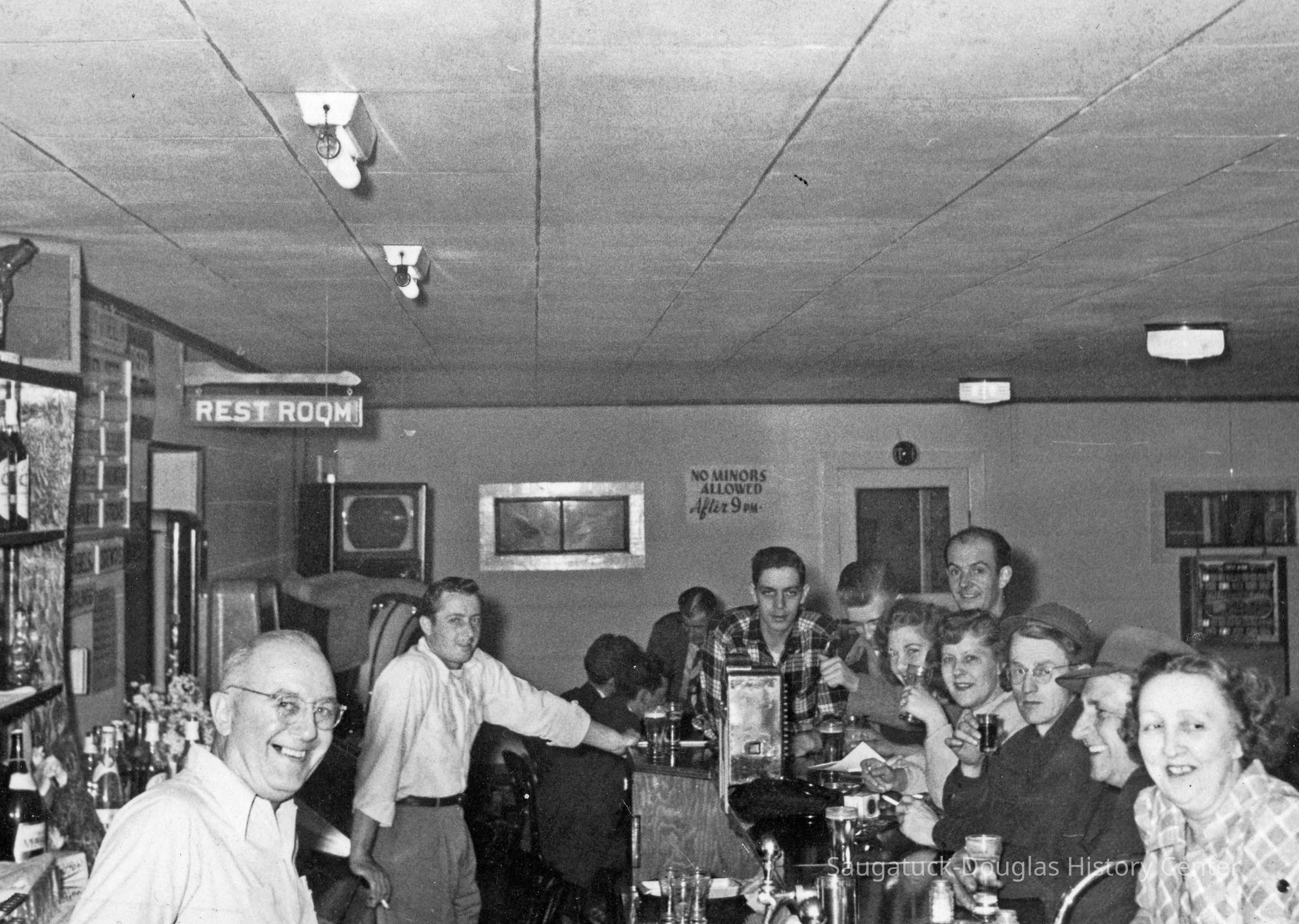HM bar scene.jpg 721KB; Front left Jack Seckel - owner Other bartender ??? Looks like Jack - maybe son?
Front right Georgia Chase Seckel / Lawrence Shoemaker / Man with glass holding shot glass Robert Dempser / woman beside him may be wife Velma / Next woman Margery Fisch Cartwright / man behind
Ralph Cartwright man fact partially hidden ? /Plaid shirt man Larry Monique
Per Howard Schultz - This is the Douglas Tavern date ca 1950. Jack Seckel is Howard’s uncle.