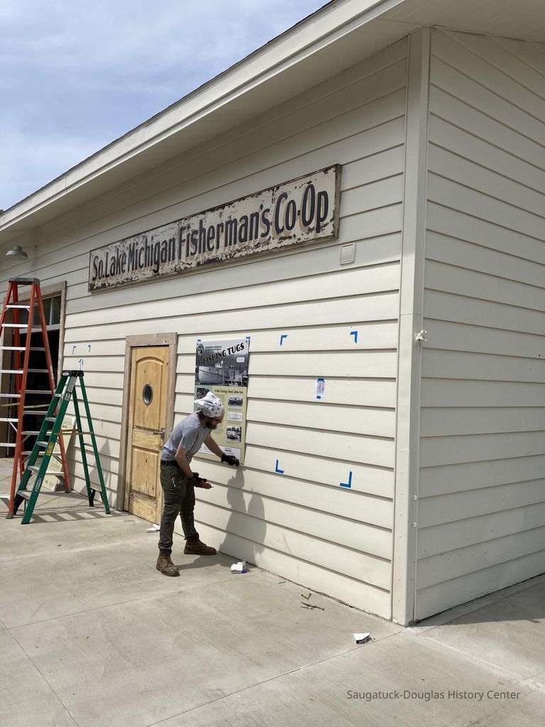 Masonite and wood sign was treated with moisture and UV-protective clear coat before installation. Sign installed on Harrington Boathouse next door to Shanty in May 2021
