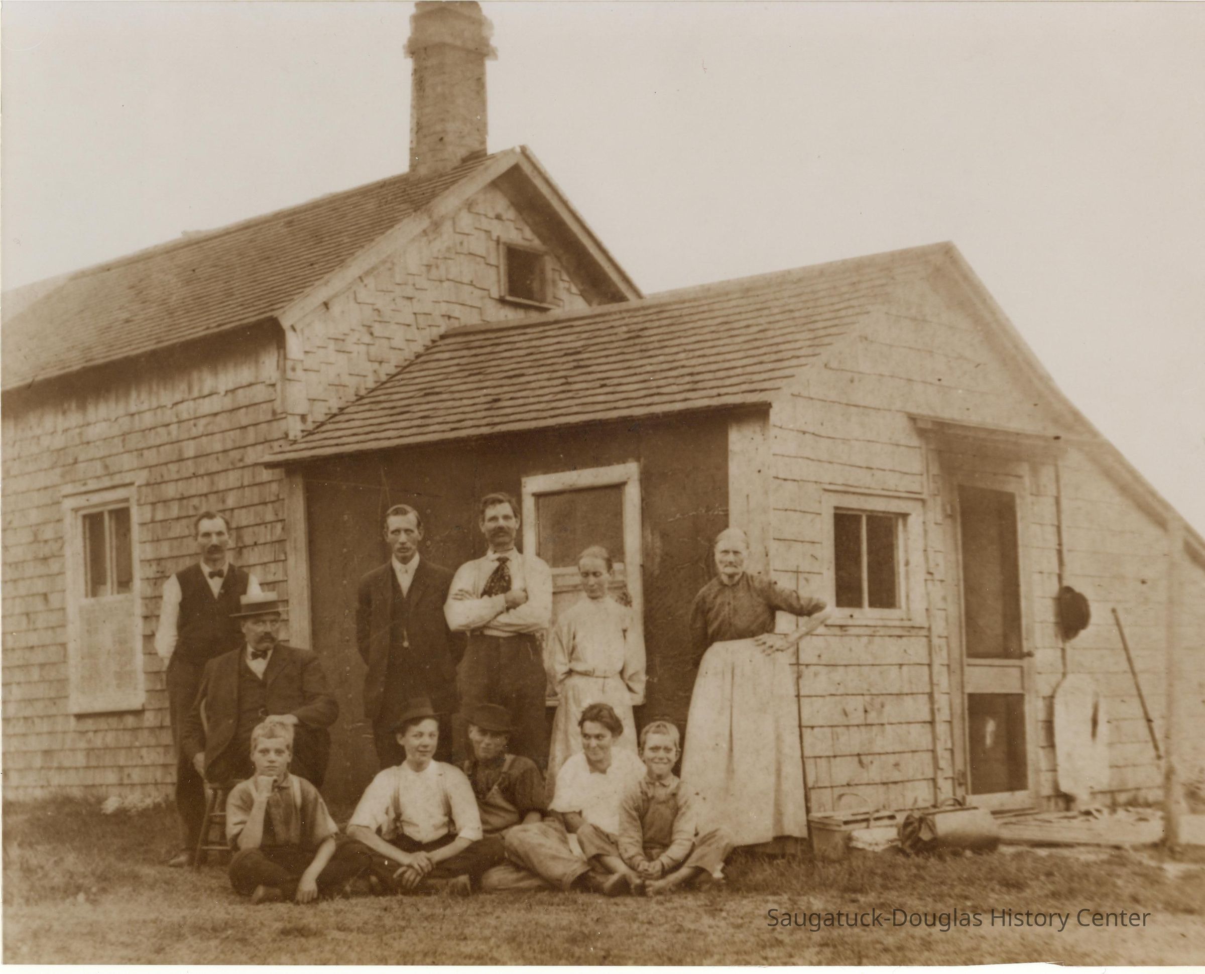          ER-AugustEricksonFamily-0001.JPG 481KB; The attached Photo shows the Gibson homestead (circa 1903), family, and several relatives. August & Ida stand in front of the window beside August's sister Sophia. Ida's brother-in-law Claus Wahlen stands at the extreme left of the photo. Children seated from left are David, Ida's nephew Carl Whalen, George, Anna and Charles. The remaining two men are unidentified (cousins?).--photo provided by Bob Erickson, April 2009
   