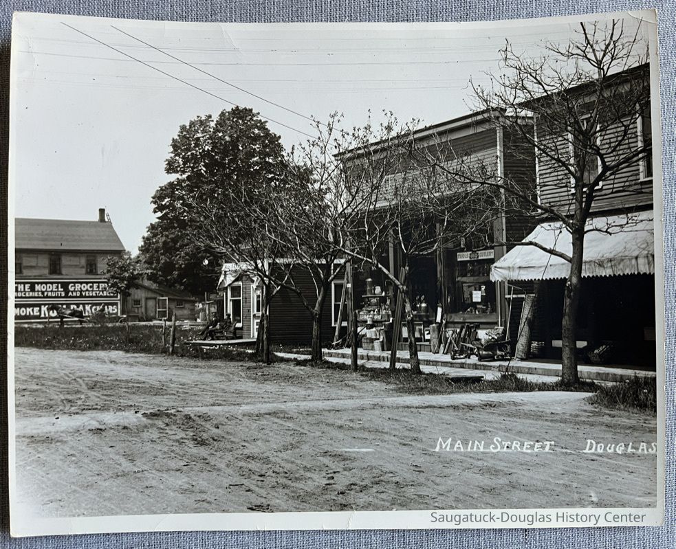          The north side of Center street between Washington and Main, probably about 1900. Stores are, from left, a barber shop, hardware and grocery.
   