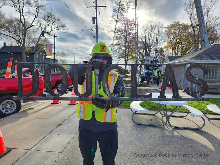          Bill's Tree Service employee holding up the sign after removal from the tower.
   