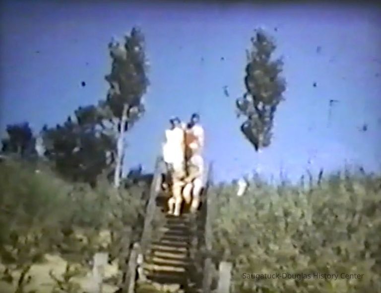          Family desending the stairs for a day of fun at Oval Beach
   
