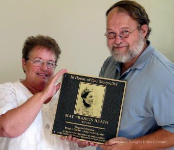 Peg Sanford and Chris Yoder with the plaque