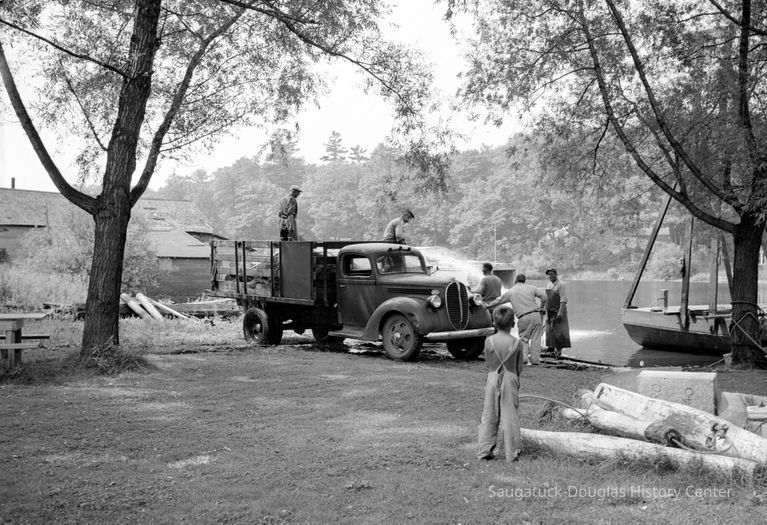 This image was featured as History Mystery #77 with the solution: In 1944, fishermen washing their nets was a daily chore in one of Saugatuck's early industries.