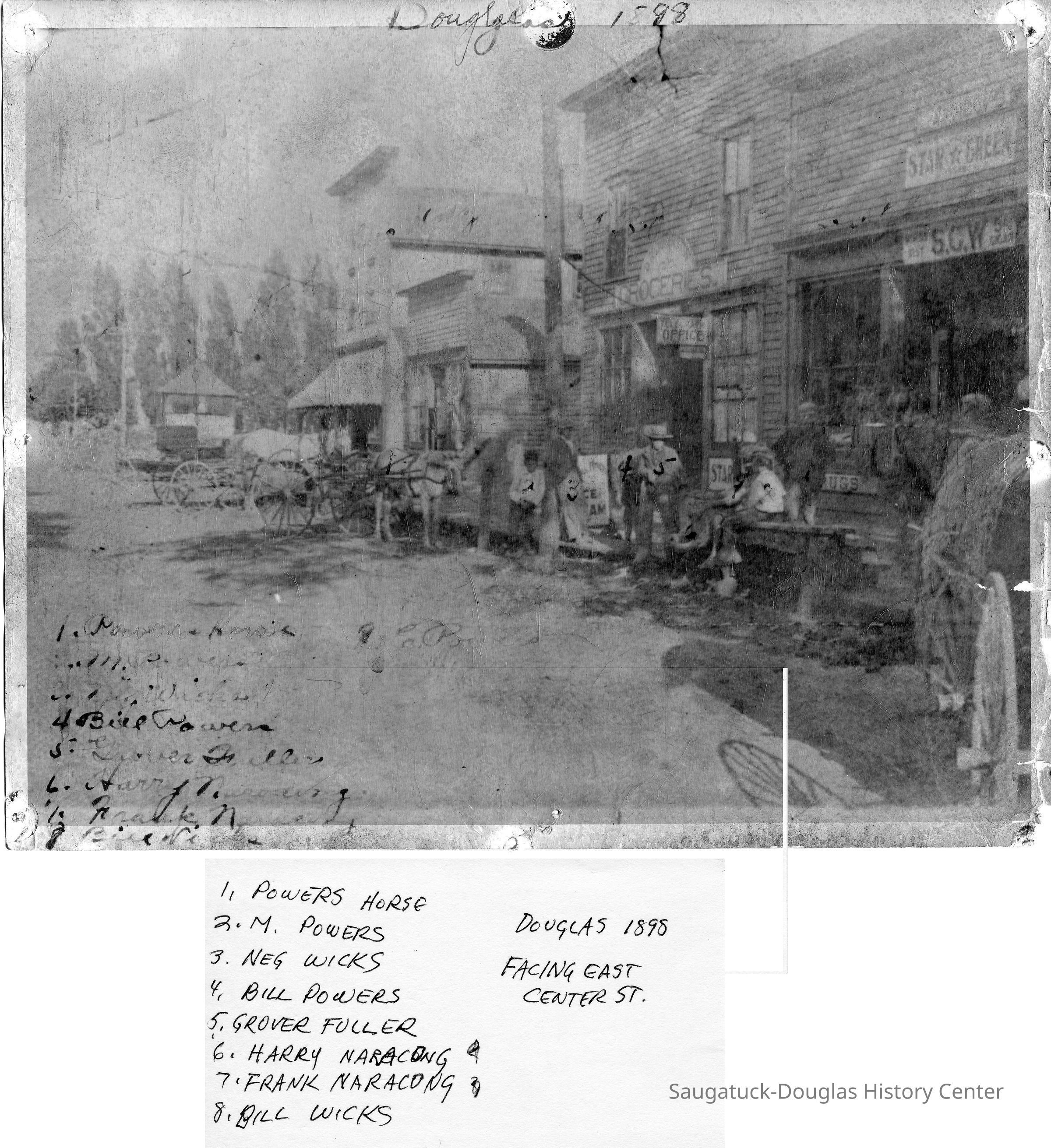          89-1-71 Downtown Douglas 1898.jpg 8.2MB; Douglas 1898  facing east Center St. -- 1. Powers Horse 2. M. Powers 3. Neg Wicks 4. Bill Powers 5. Grover Fuller 6. Harry Naracong 7. Frank Naracong 8. Bill Wicks 
Sins on the storefront says S.C.W., Star Green and groceries
   